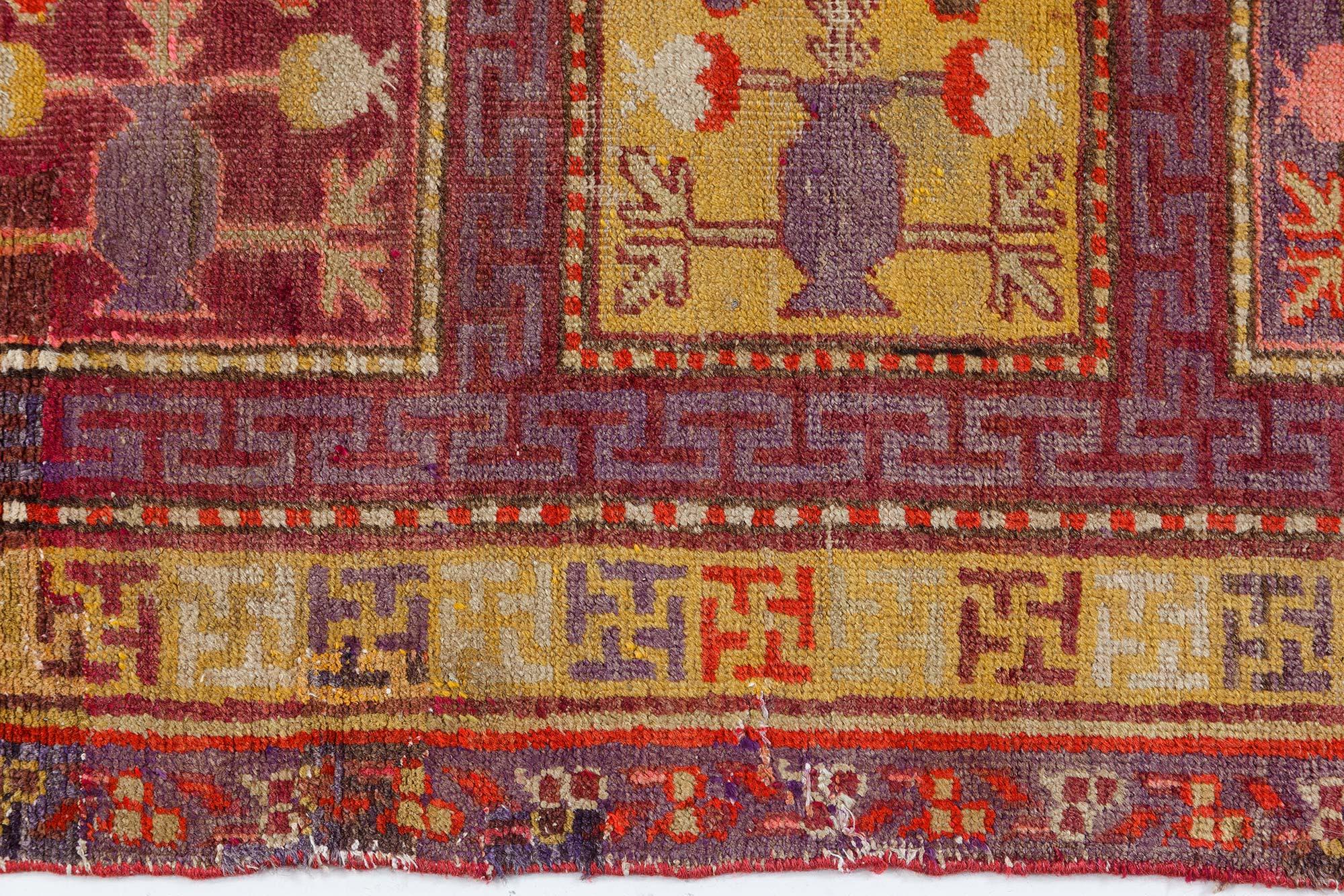 Mid-20th century Khotan 'Samarkand' handmade wool rug in purple, red and yellow.
Size: 4'11