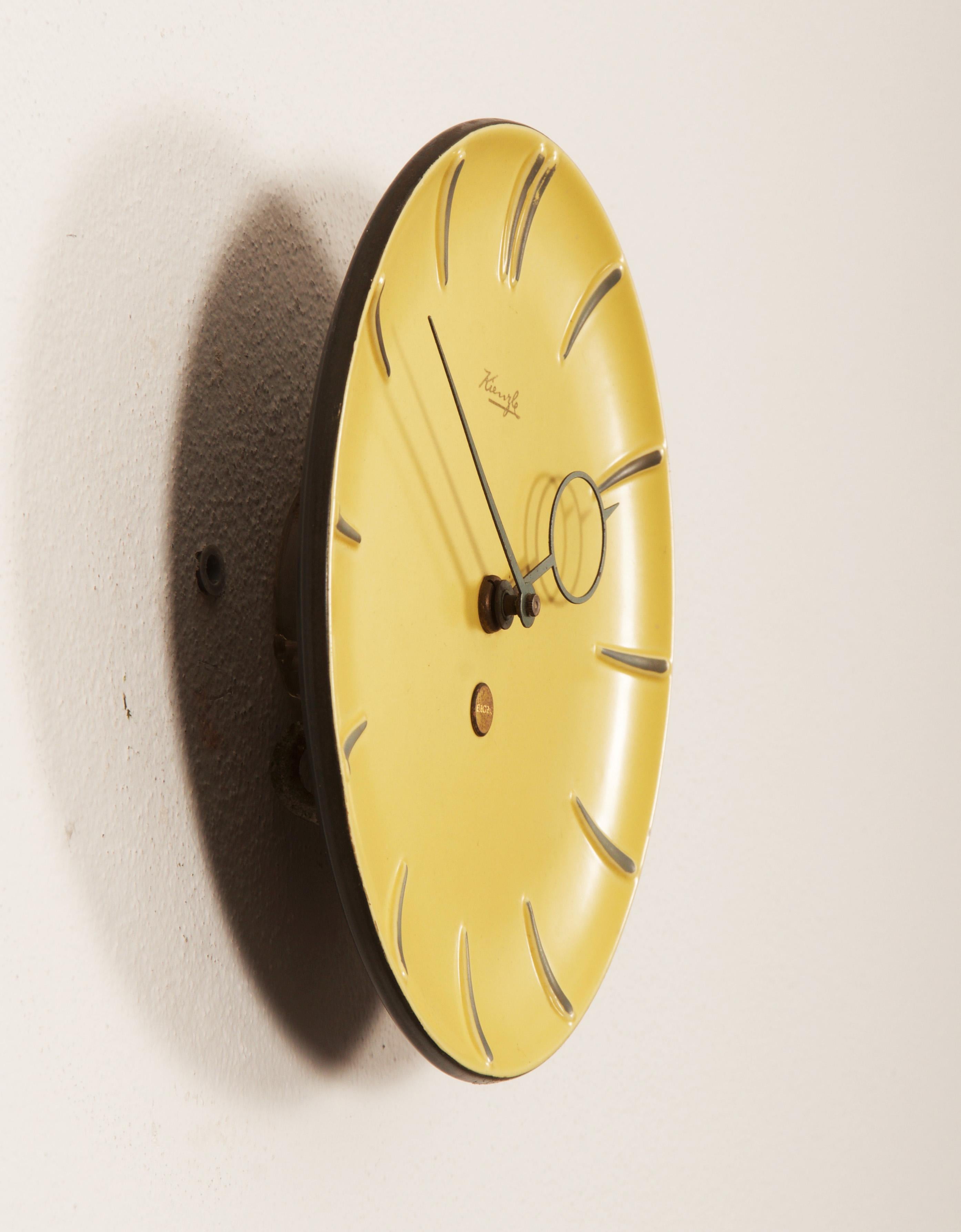 Ceramic clock face glazed and brass hands made by Kienzl in the late, 1950s. Fitted with a modern quartz movement with a battery.
     