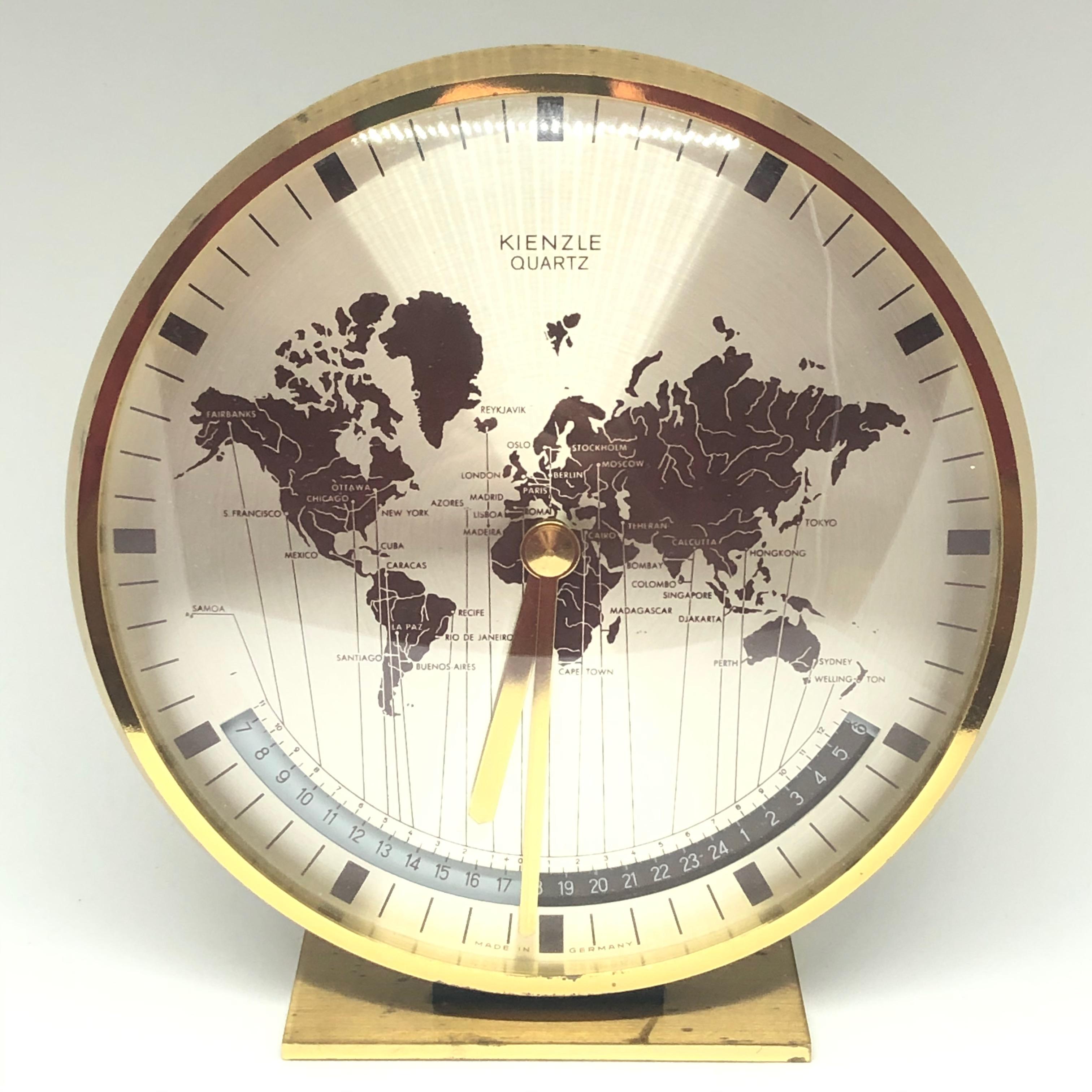 A beautiful modernist brass desk clock with a world map clocks face and world time zones. Executed in the 1960s by Kienzle, Germany. Original battery movement. In very good condition, brass with tarnished spots and patina, but this is old-age.