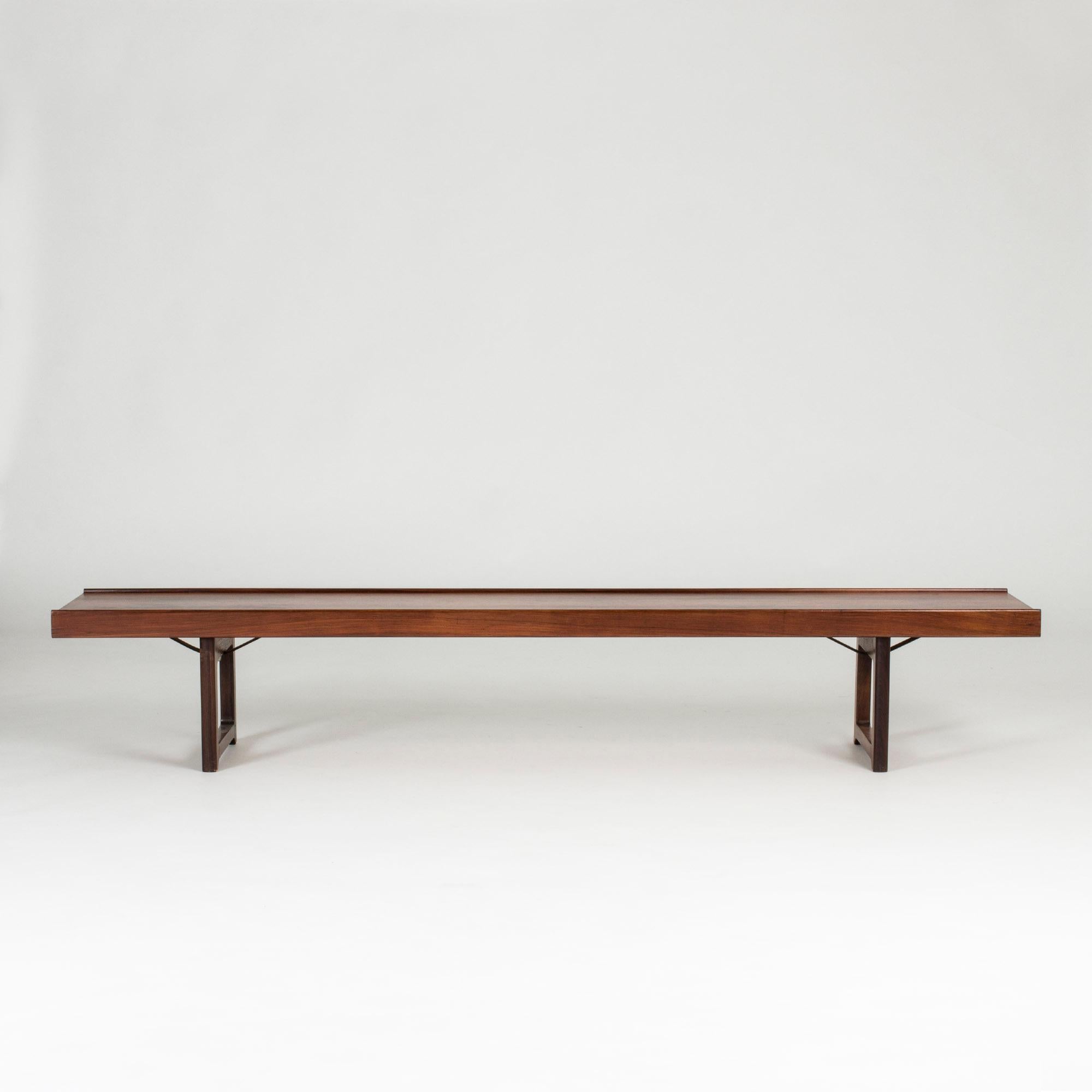 Sleek rosewood “Krobo” bench by Torbjørn Afdal, with black metal extenders underneath. Great as a sideboard or room divider.
