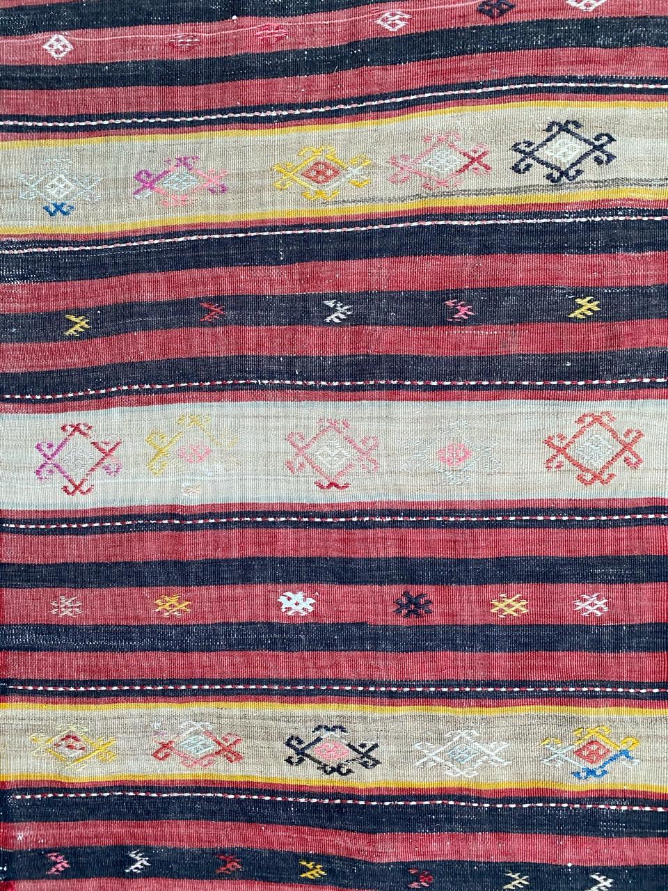 Beautiful Kilim with a tribal design and beautiful colors with red, brown, blue, orange and pink, entirely handwoven with wool on cotton.
