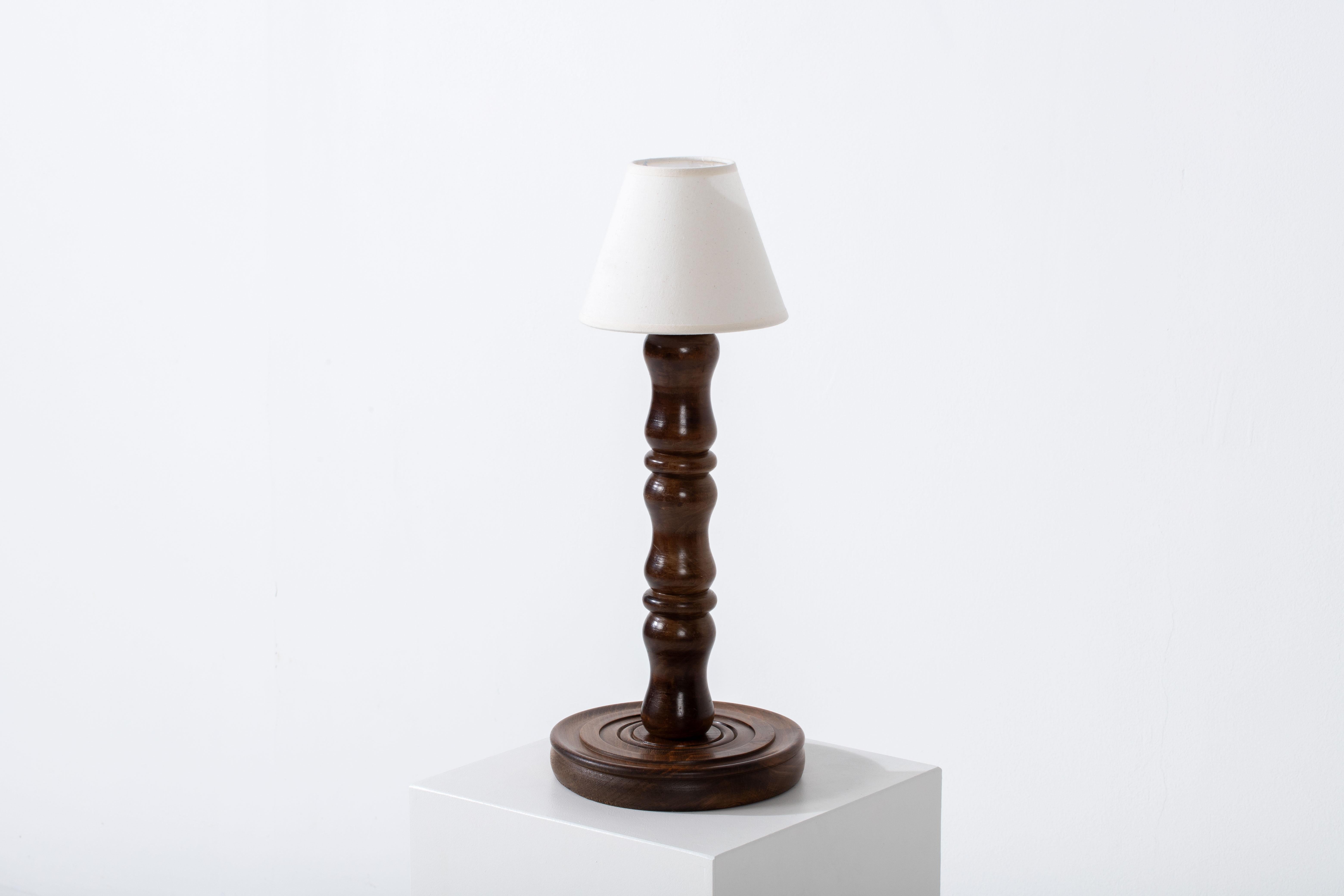 Illuminate your space with the enchanting glow of this exquisite table lamp, a true embodiment of timeless French elegance. Crafted during the 1950s, this lamp stands at a height of 42 cm, making it a versatile addition to any room.

The lamp's