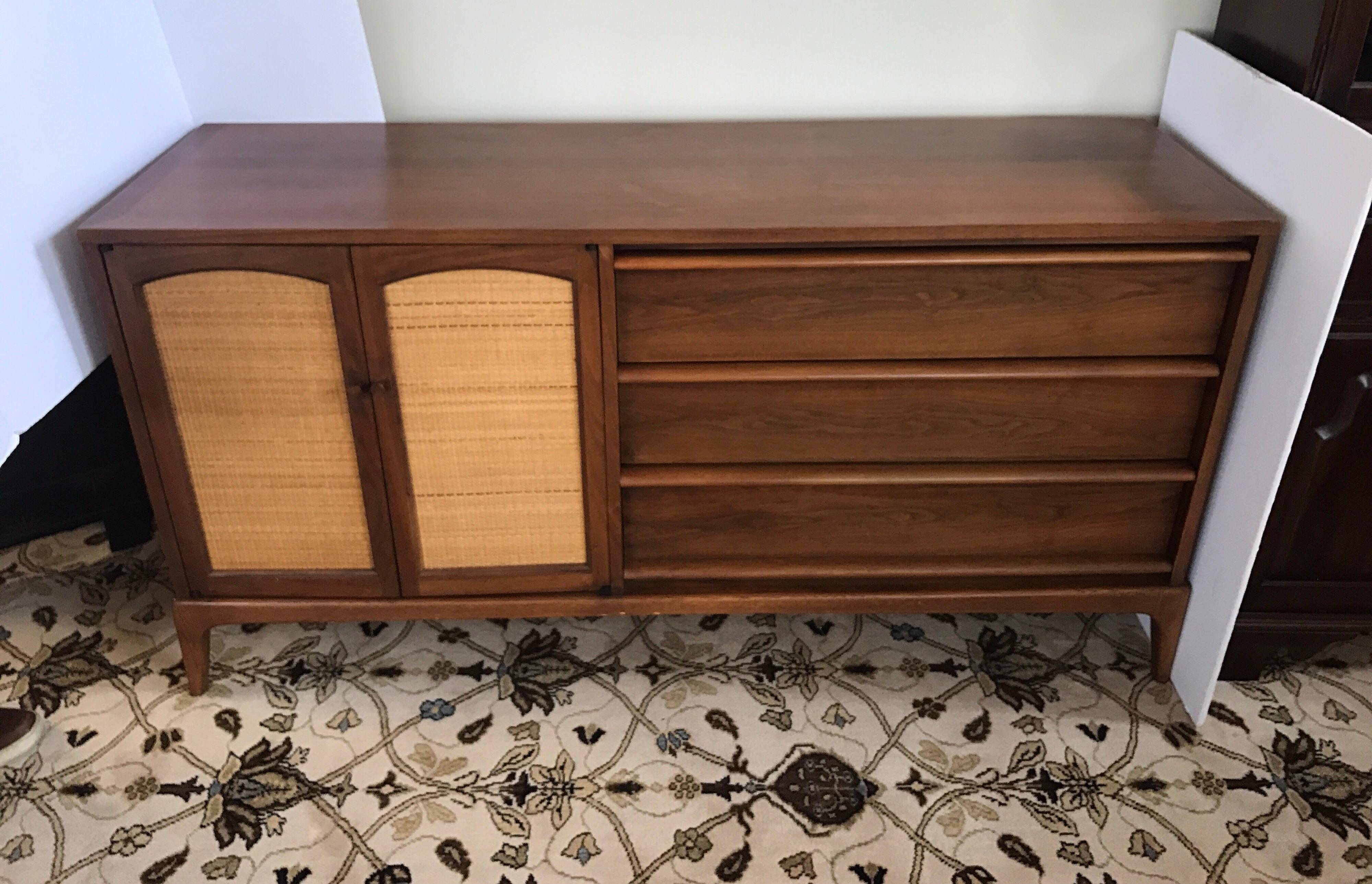 Walnut dresser by Lane Altavista with three drawers at right and two rush front doors on left whose inserts are removable. Condition is excellent. Can be used as an entertainment console or dresser.
 