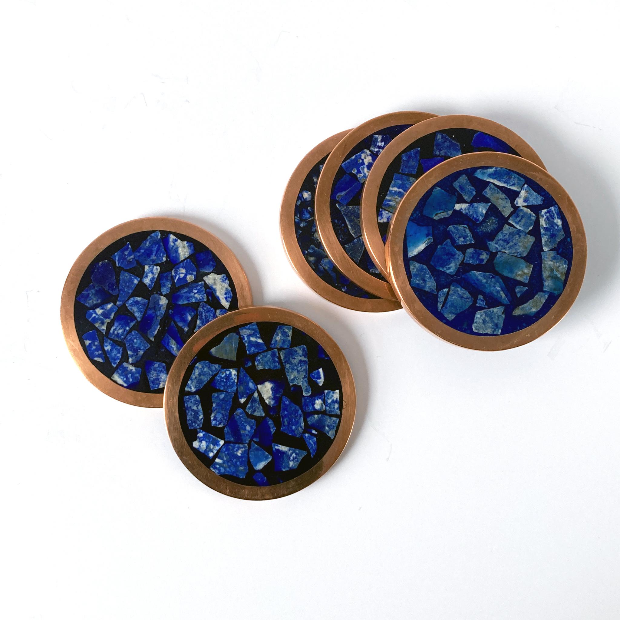 Stunning set of six lapis lazuli coasters, rimmed in copper. The pattern of the mosaic contrasts beautifully with the copper; the lapis is luminous in shades blue with some flecks of tan and ecru. These coasters would look wonderful as part of a bar