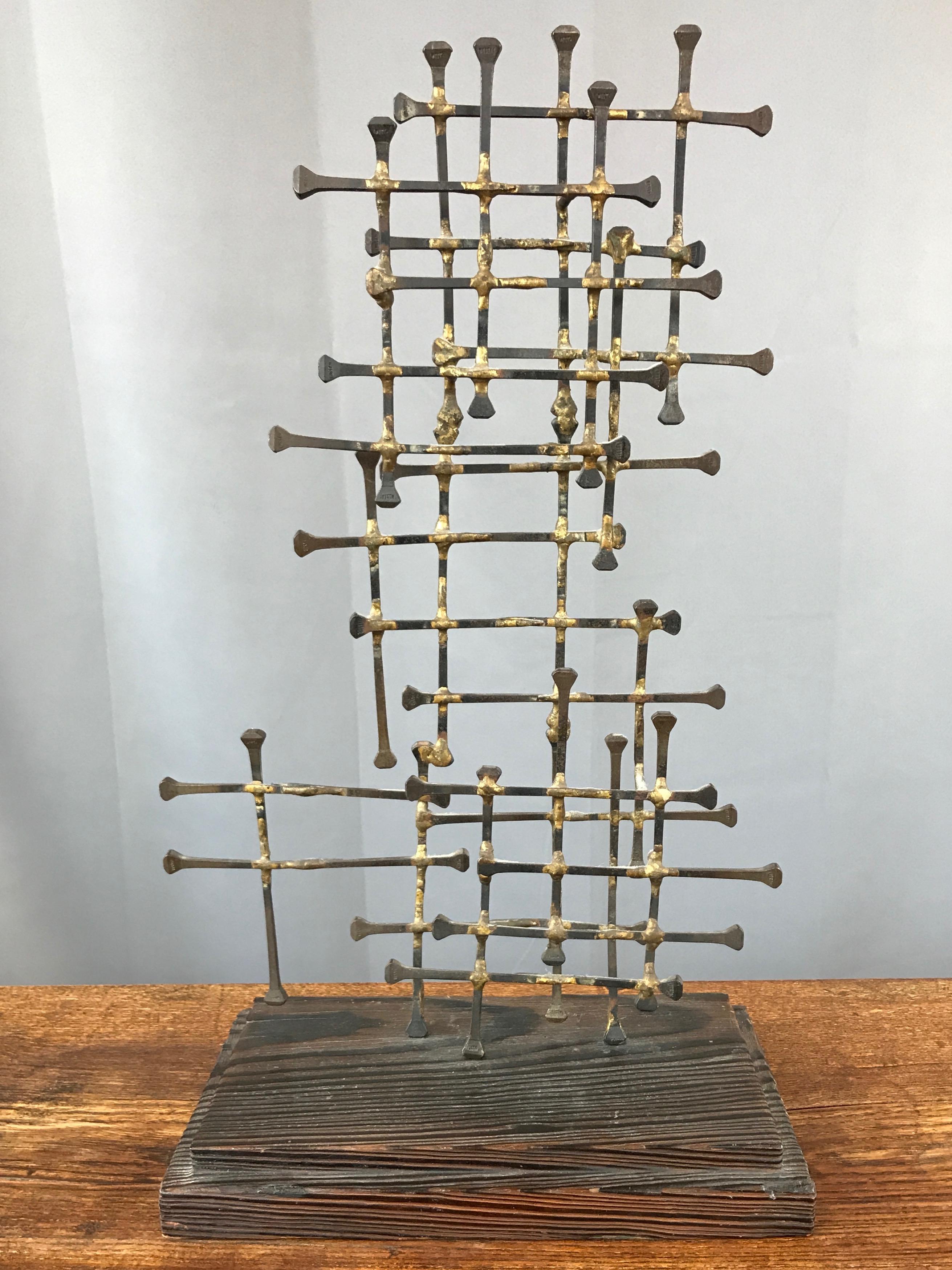 A large Brutalist abstract nail art sculpture on wood base, circa 1950s.

Oversized blackened iron nails with brass welds arranged in a loose, layered grid design. Evokes Charles & Ray Eames’ “Dot Pattern” textile, giving it a very Mid-Century