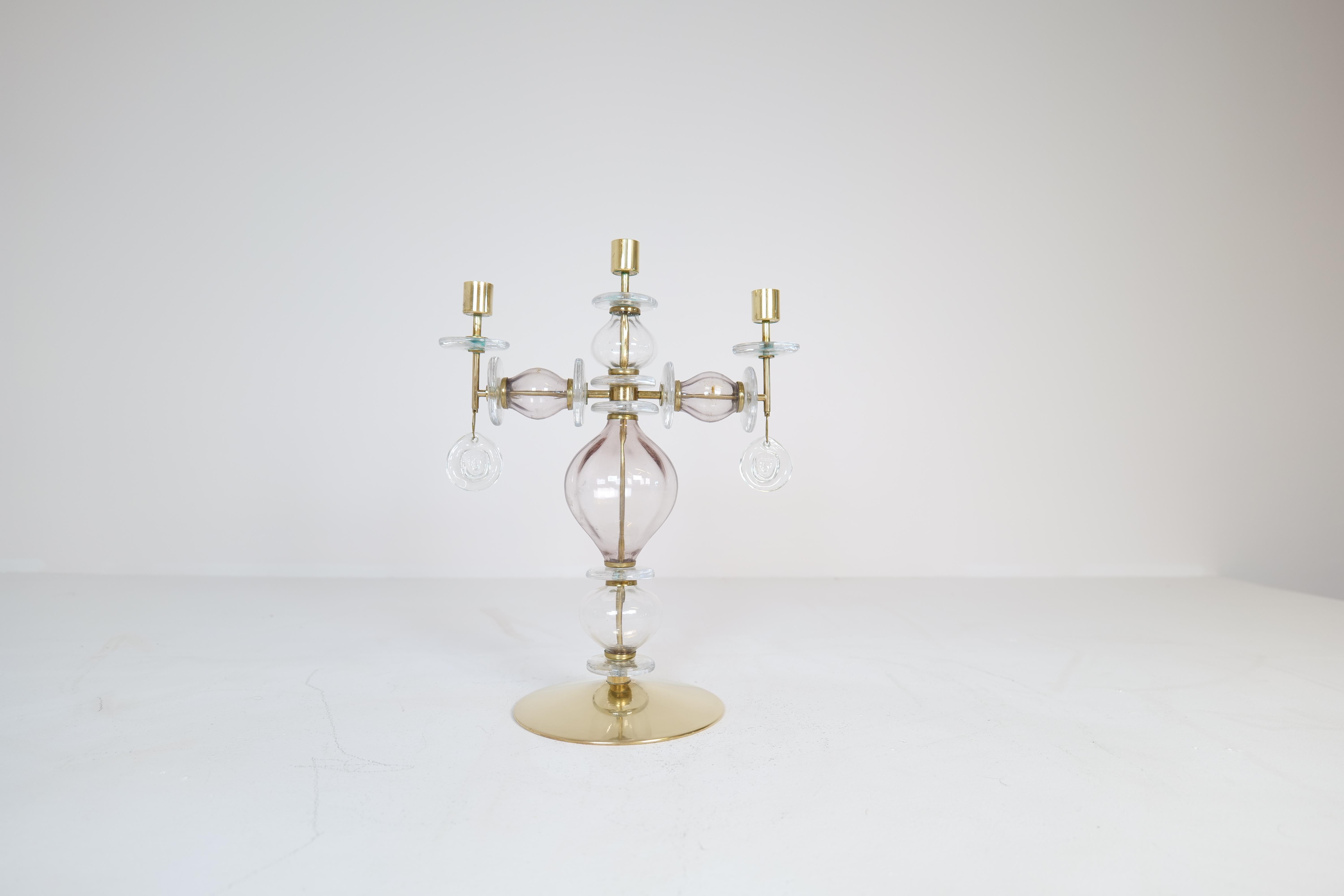 This large and not often found candelabra was manufactured at Boda and designed by Erik Höglund in Sweden during 1960-1970s.
Art handmade glass working perfect with the brass parts of the piece. The glass in white and purple color. 

Good vintage