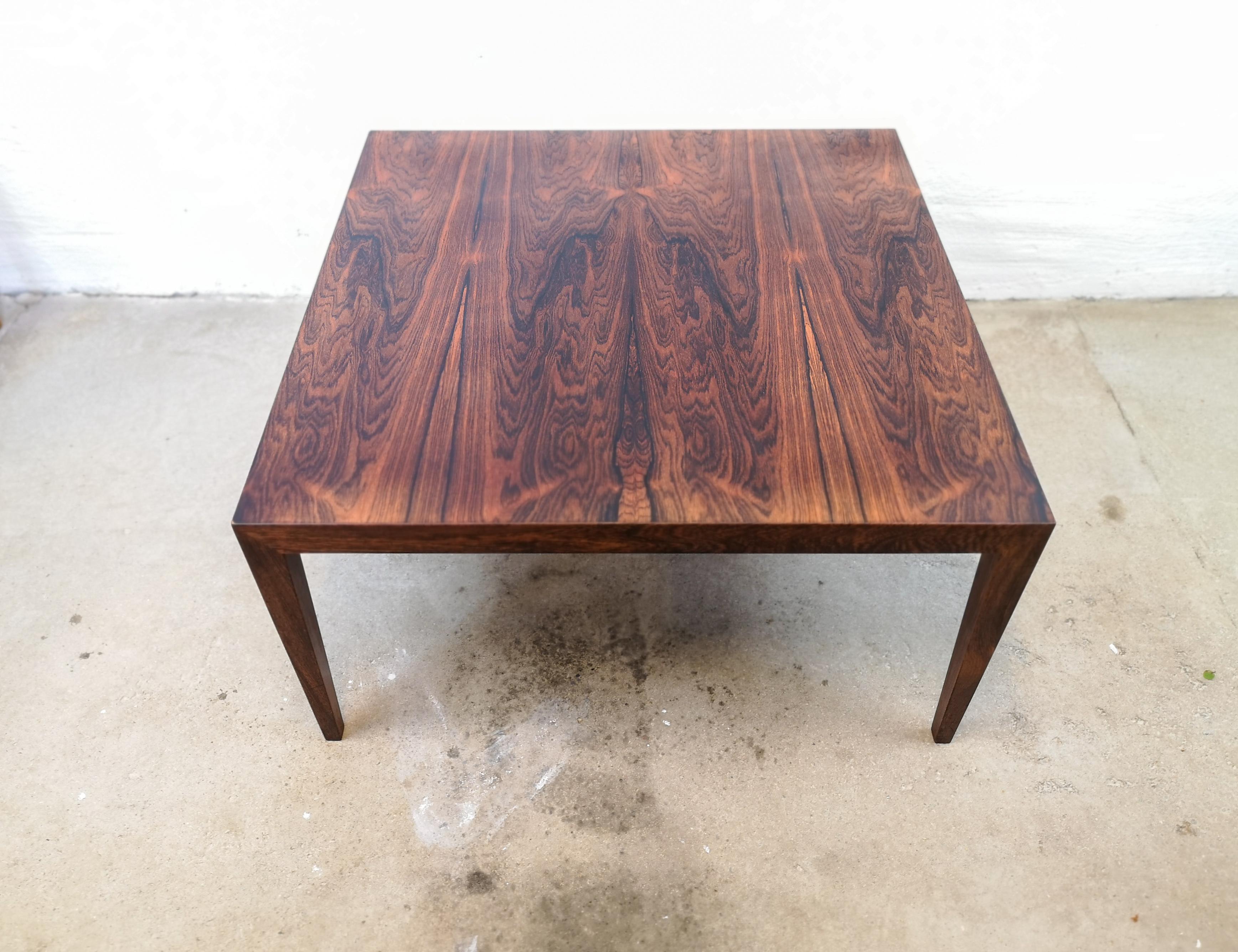This stunning coffee table was produced in Denmark at Haslev Mobelsnedkeri. Its designed by Severin Hansen. His designed is easily recognized if you look at where the legs meet the top. Perfectly match they are and makes the table look like a piece