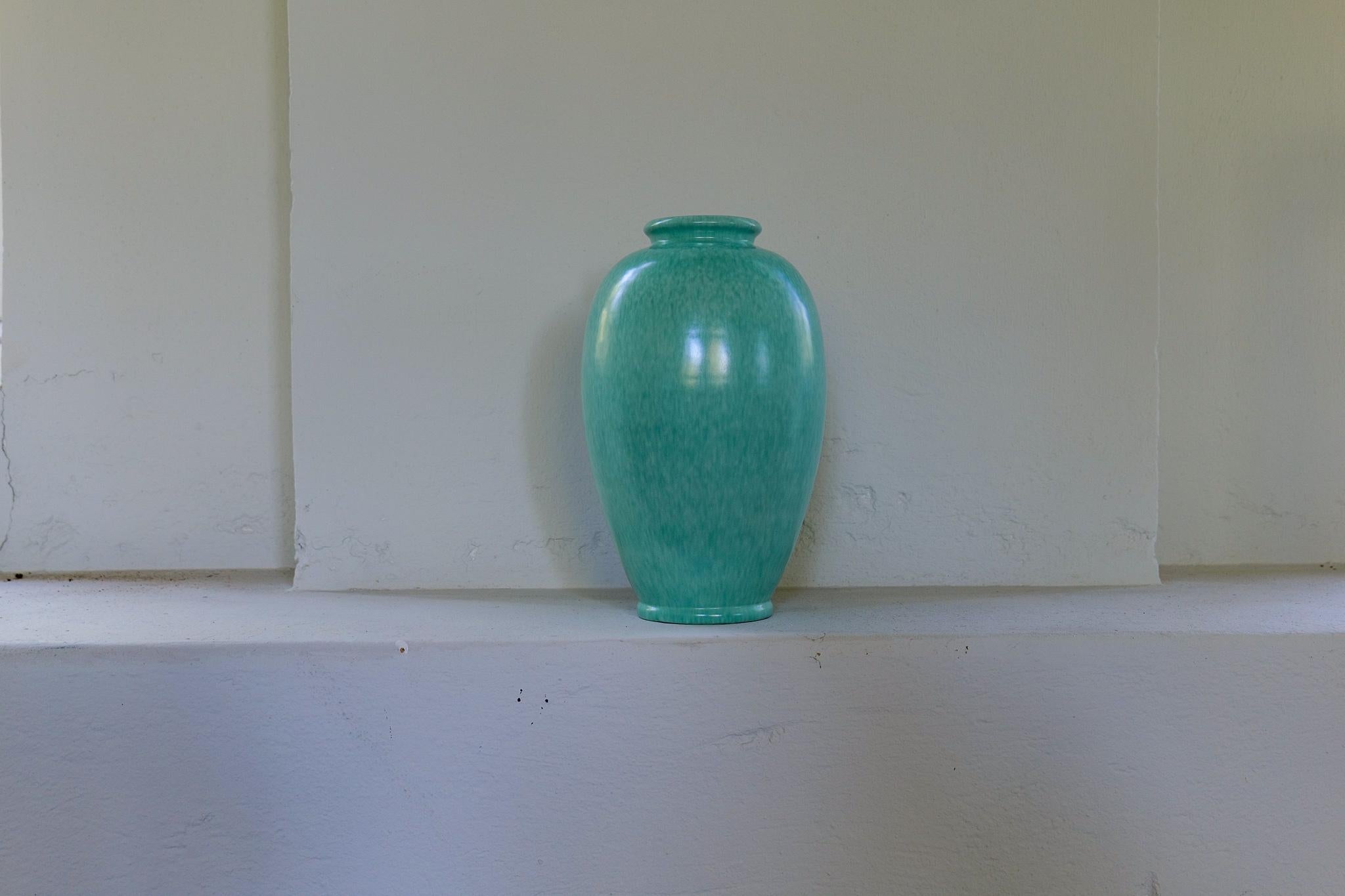 This wonderful, sculptured floor vase was created / designed by John Andersson for Höganäs Keramik Sweden 1960s.
The shape and the turquoise glaze are stunning. 

Good vintage condition. 

Dimensions: height 40 cm middle part diameter 22 cm top