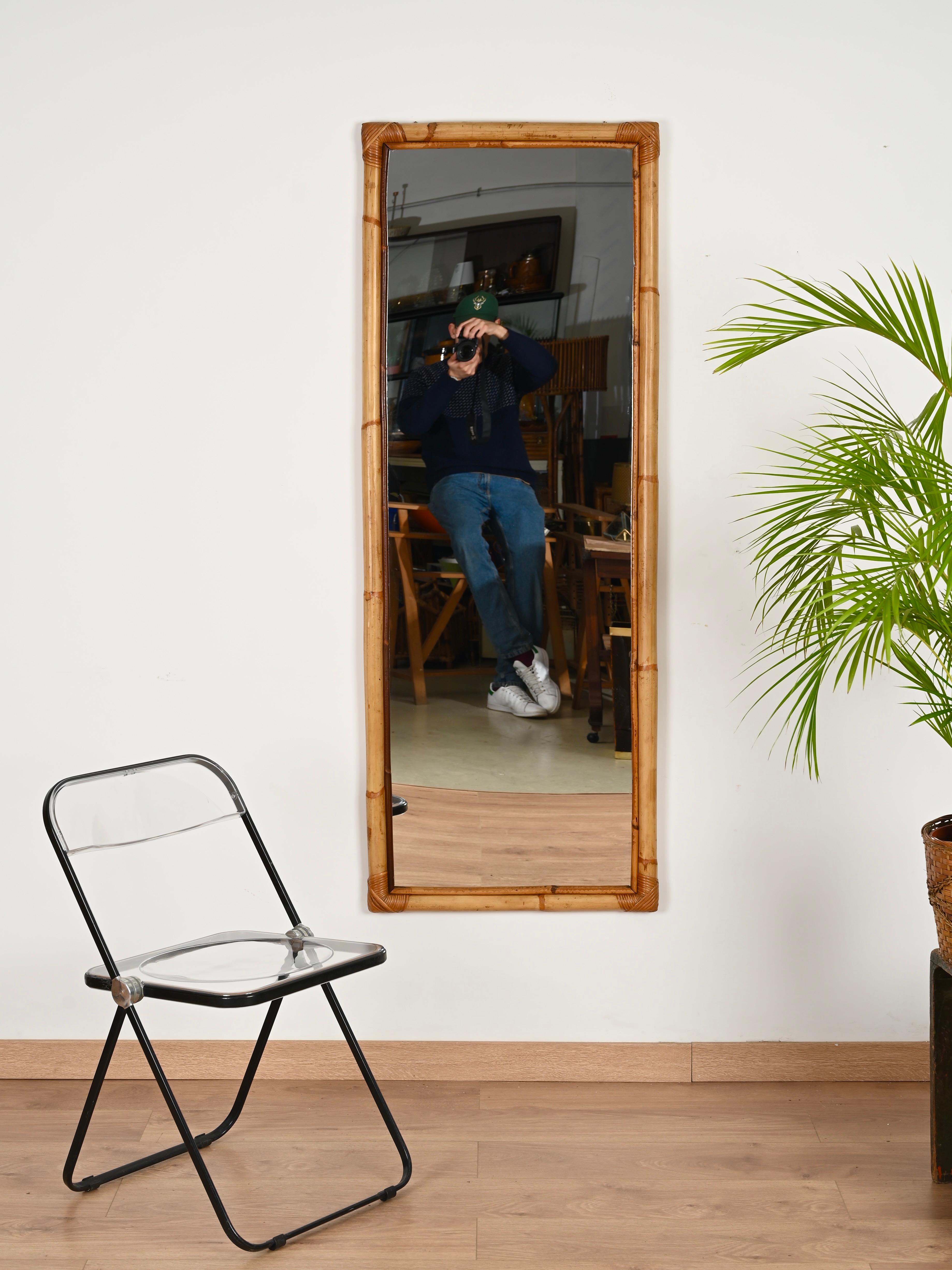 Gorgeous  large rectangular full-length midcentury mirror in bamboo and hand-woven wicker. This elegant organic mirror was designed in Italy during the 1970s. 

In fabulous condition and with a charming honey-like color. The mirror has a wonderful