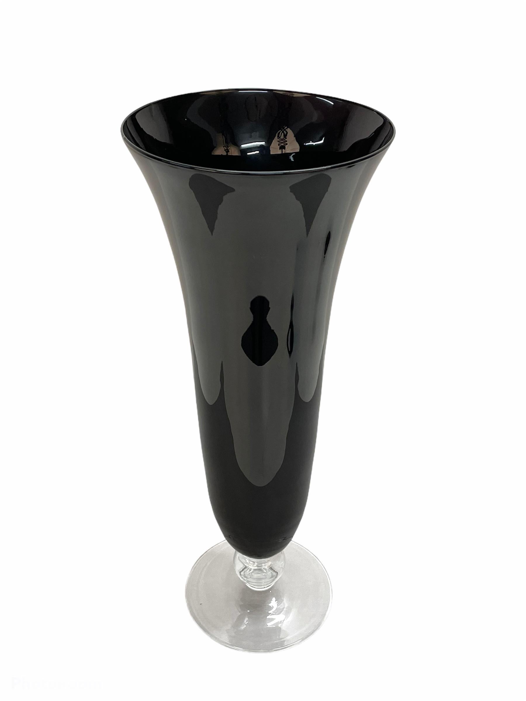 Amazing midcentury large black glass artistic vase with crystal base. This fantastic item was designed in Italy during the 1980s.

This piece is very elegant as it has a very slick design with simple and chic lines. It features a solid black glass