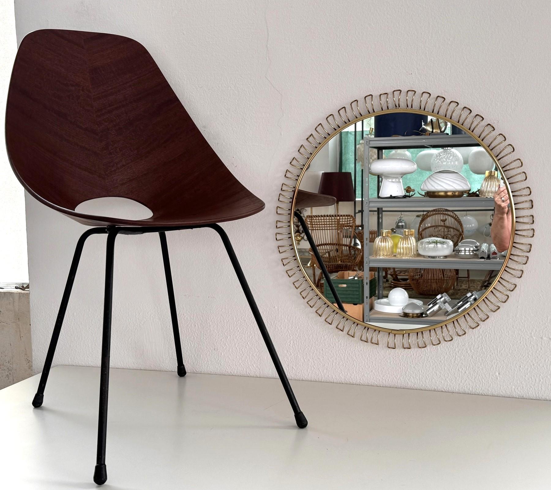Gorgeous large round sunburst wall mirror with round loop metal decorations and brass finish.
Made in Germany in the 1970s.
The mirror is in all original condition with the original glass, which shows some very small dots under the glass ( please