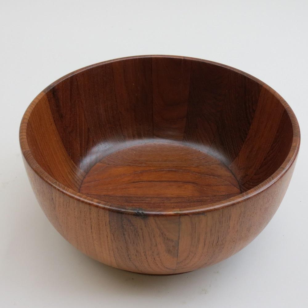 Large wooden bowl from the 1970s. Made from blocks of solid Teak. Stamped to the underside Mandalay Genuine Teak. 
In good over all condition, the bowl has been professionally repolished.