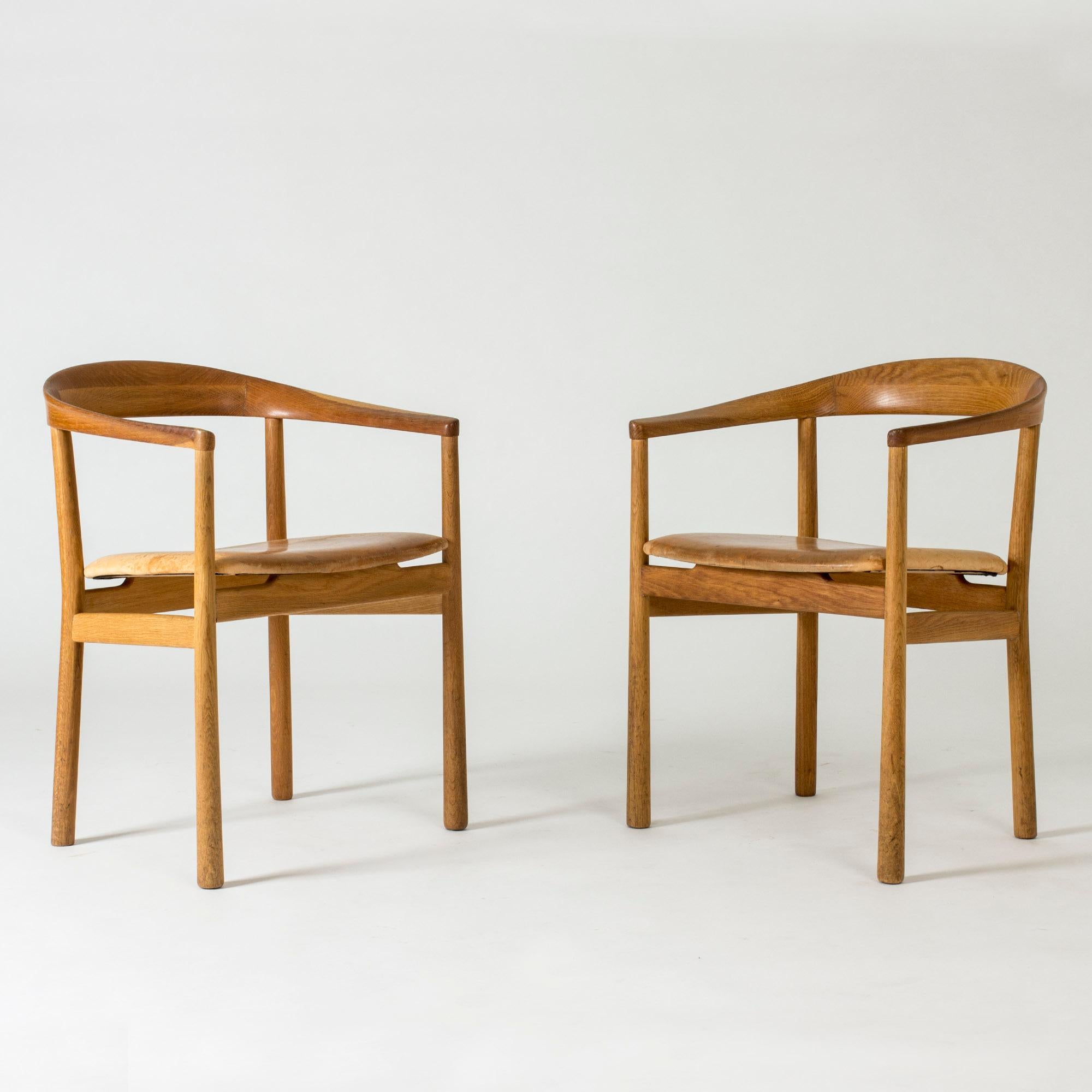 Pair of elegant “Tokyo” armchairs by Carl-Axel Acking, made from oak and upholstered with natural leather, heavily patinated. The “Tokyo” model was created in 1959 for the Swedish embassy in Tokyo.