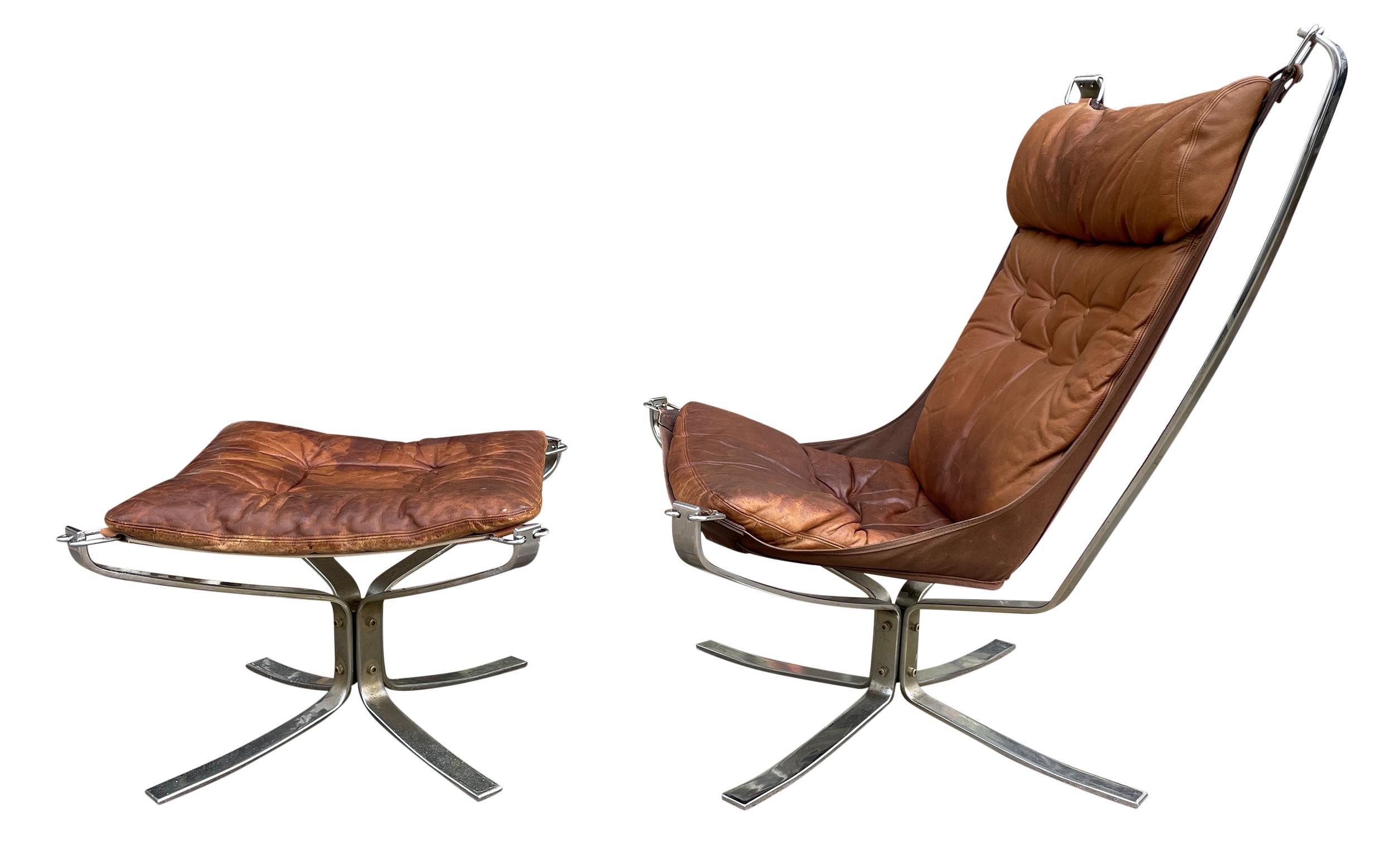 Midcentury Leather chrome lounge chair and ottoman by Sigurd Ressell. Falcon Chair and ottoman. Leather is distressed and broken in - Shows signs of wear. All straps are in good shape and canvas is tight. Canvas was replaced on the ottoman. Chair