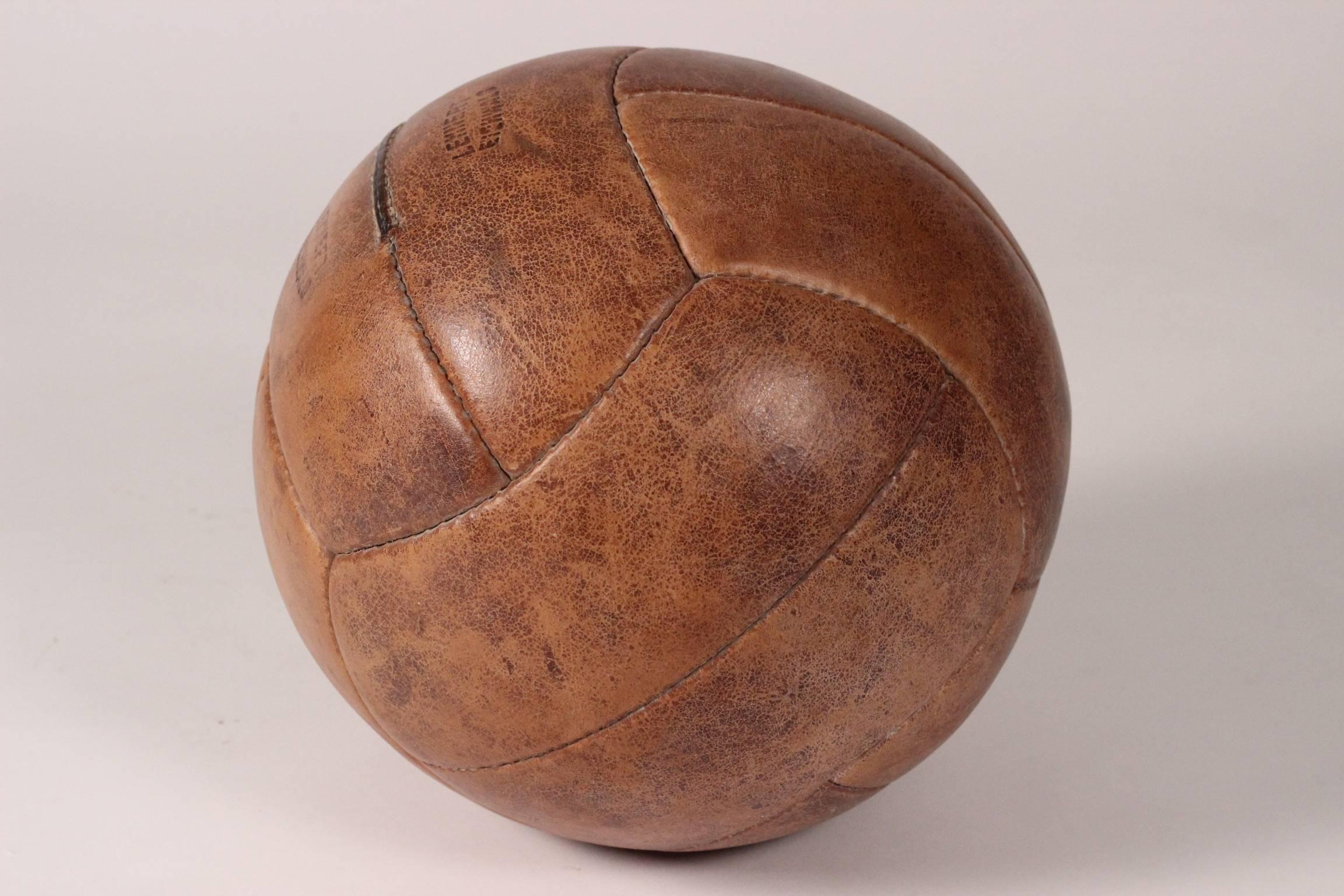 A wonderful vintage medicine ball, showing all the signs of wear of hard gym work through the years.