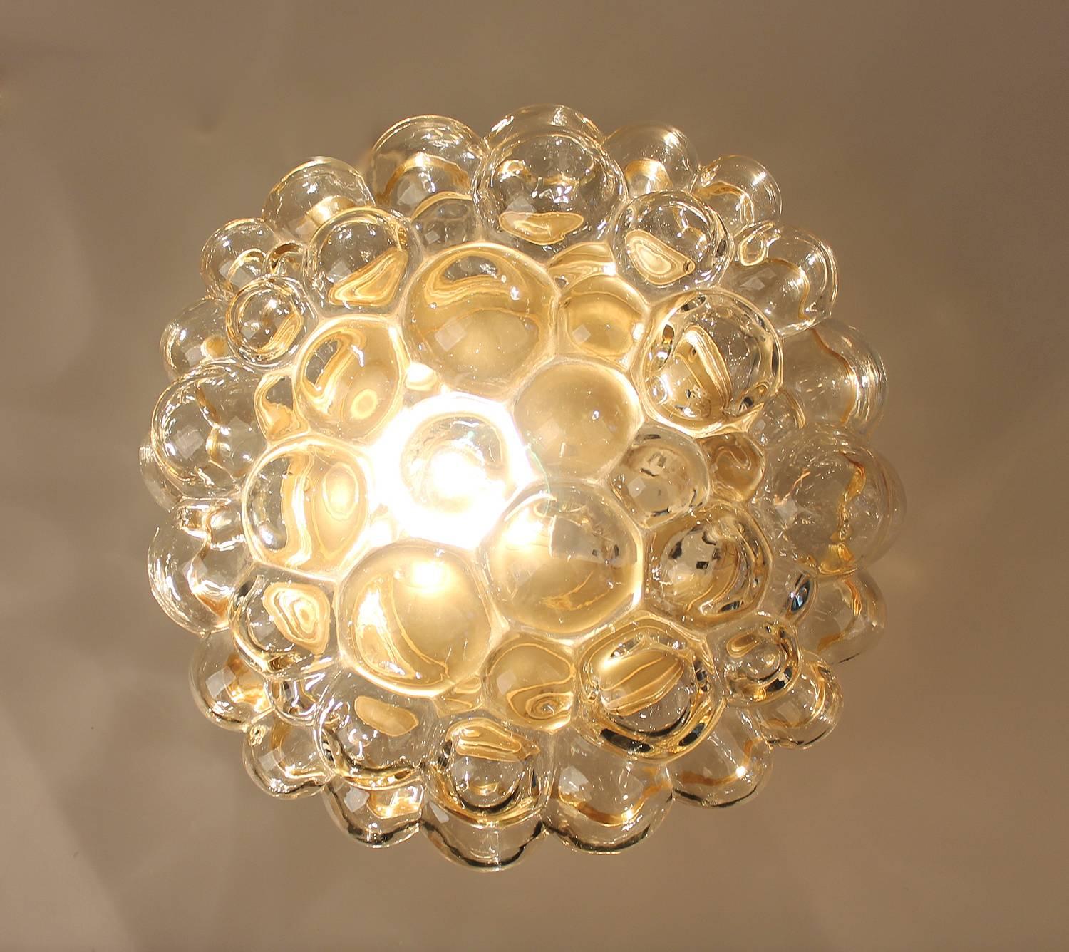 Large Limburg blown glass sconce / flush light, design by Helena Tynell, 
glass has slight amber color, bronze enameled base.
Dimensions:
H 5.52 in. x Dm 11.82 in.
H 14 cm x Dm 30 cm
Two standard bulbs up to 60 watts each.





 