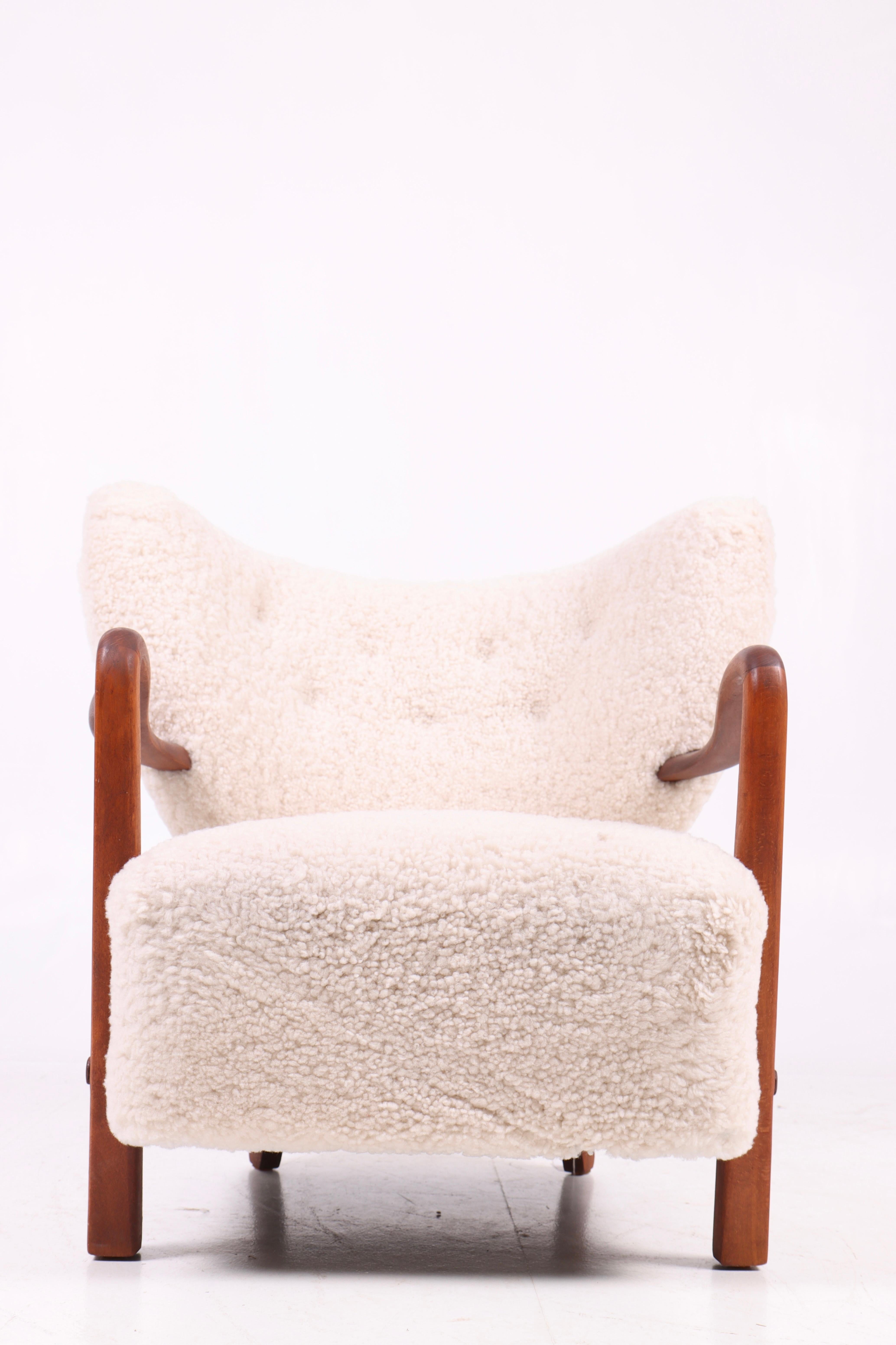 Great looking and very comfortable lounge chair reupholstered in wool, designed by Danish Wulff