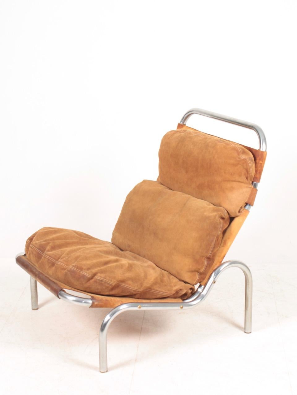 Lounge chair in suede and steel, designed by Erik Ole Jørgensen for Georg Jørgensen & Søn. Original condition.