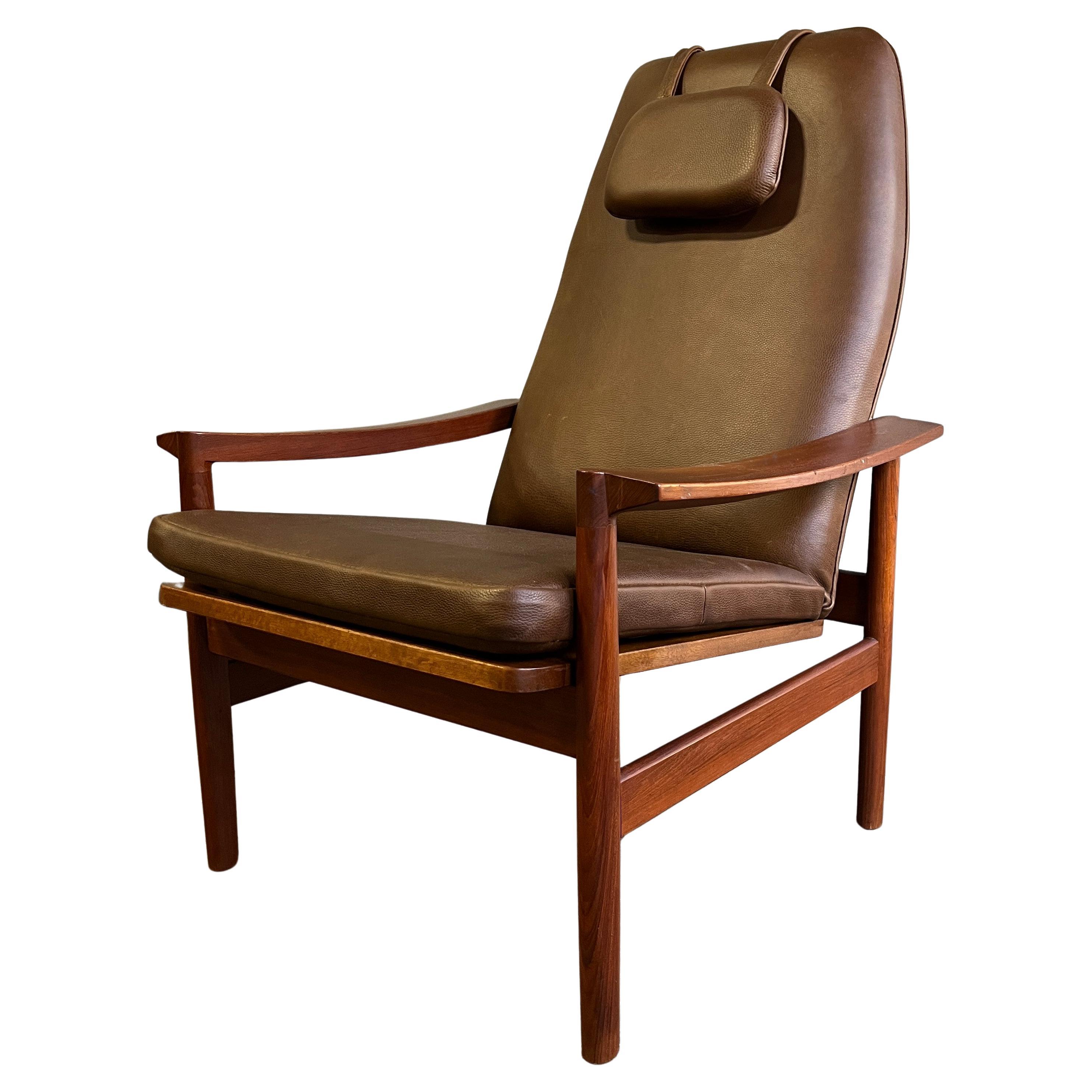 Beautiful Mid-Century Scandinavian Lounge / reclining chair in teakwood with dark thick saddle brown leather. Newly upholstered. Has three positions to recline. Sleek design and wonderful patina. As comfortable as it looks!