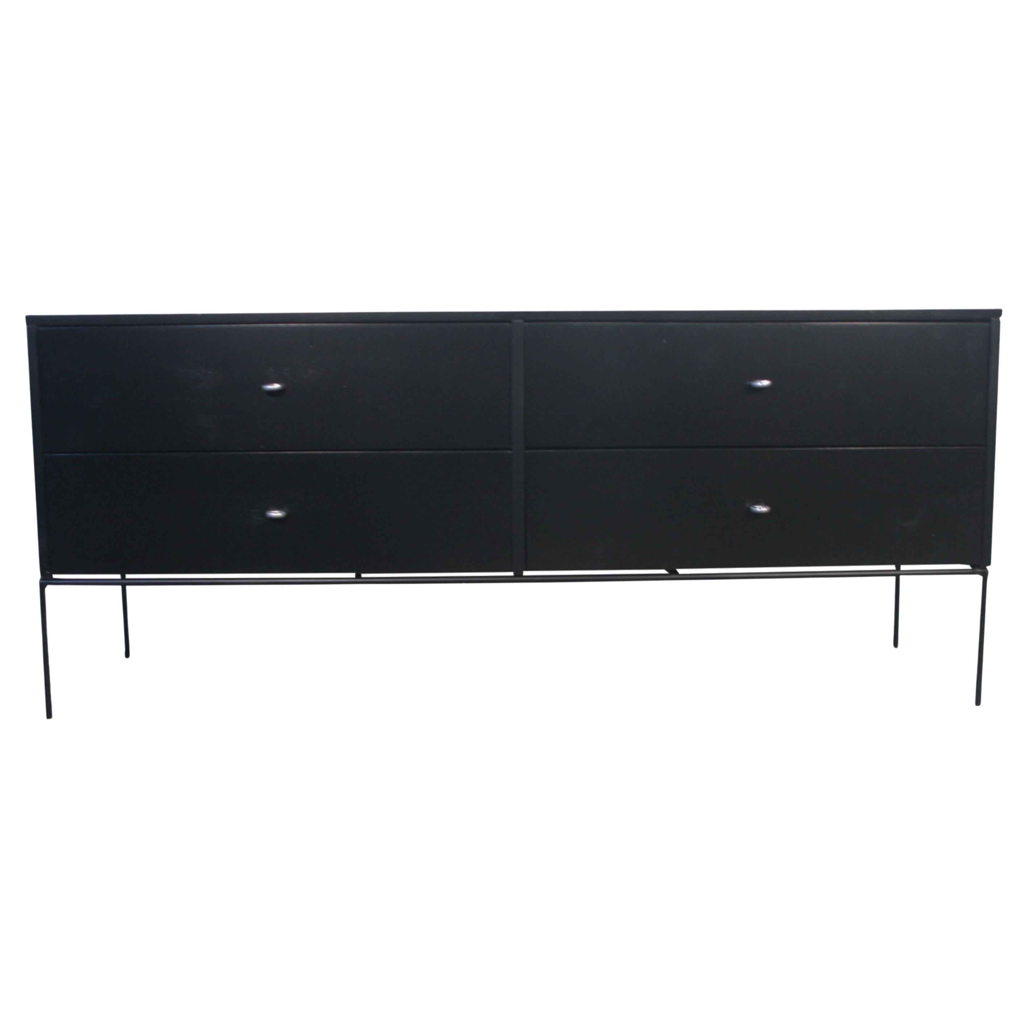 Beautiful mid century low dresser credenza by Paul McCobb circa 1950 Planner Group #1504 with 4 drawers - solid maple construction has a Black Lacquered finish. All original aluminum ring pulls sits on an iron Base with 4 legs. Refinished in Black
