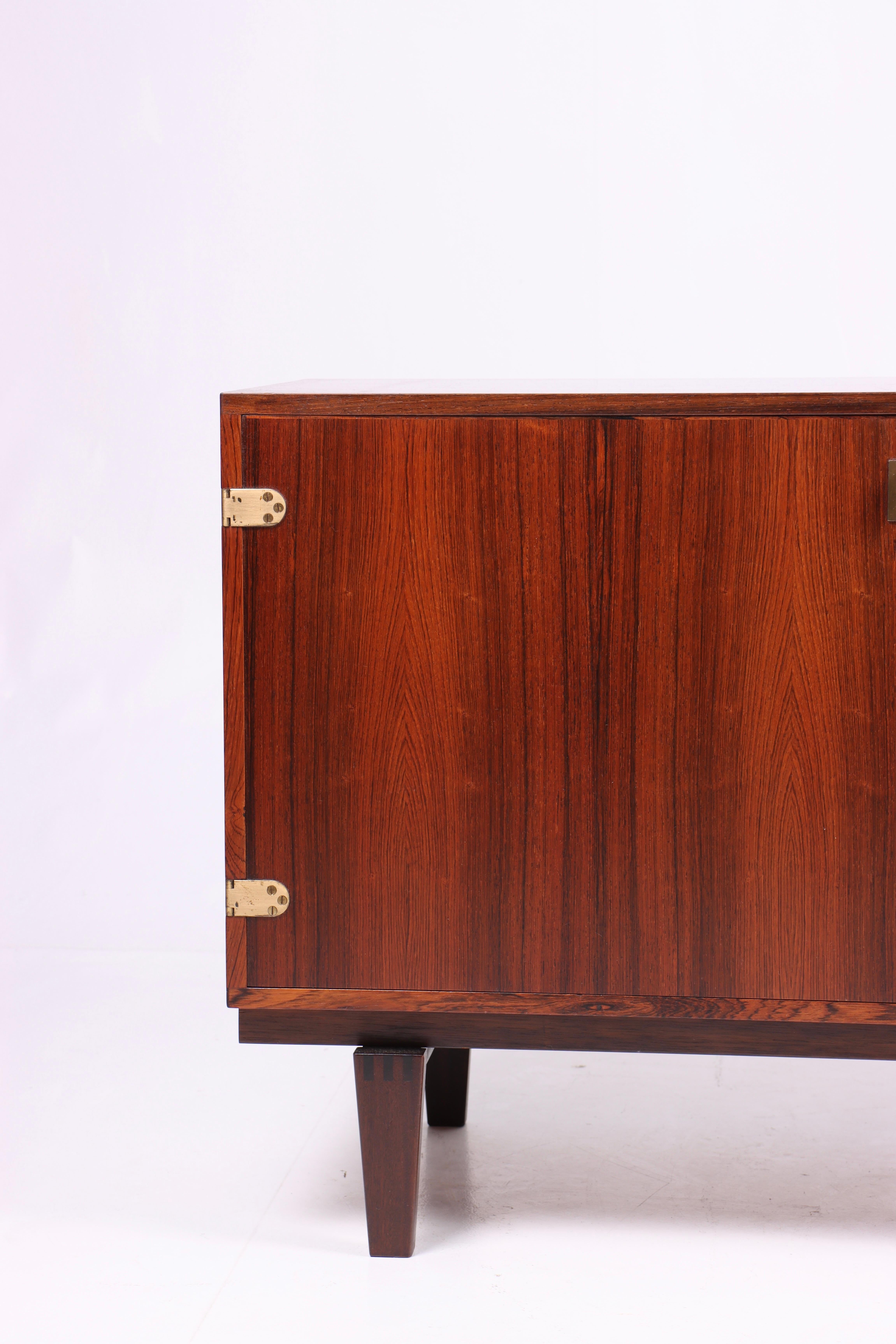 Cabinet in rosewood with brass hardware. Designed by Peter Løvig Nielsen, Denmark in the 1960s. Great original condition.