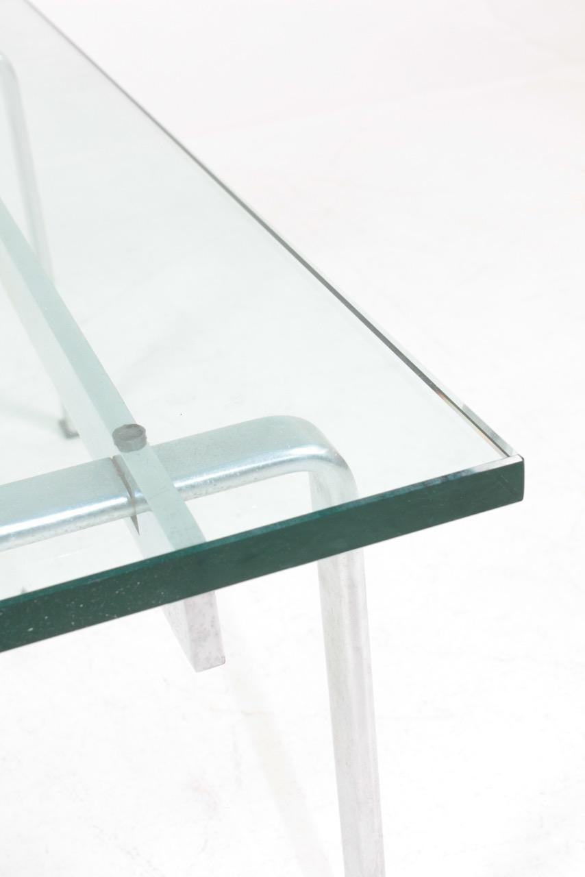 Low table with glass top on a stainless steel base. Designed by Maa. Jørgen Fabricius & Preben Kastholm for Kill International. Great original condition.