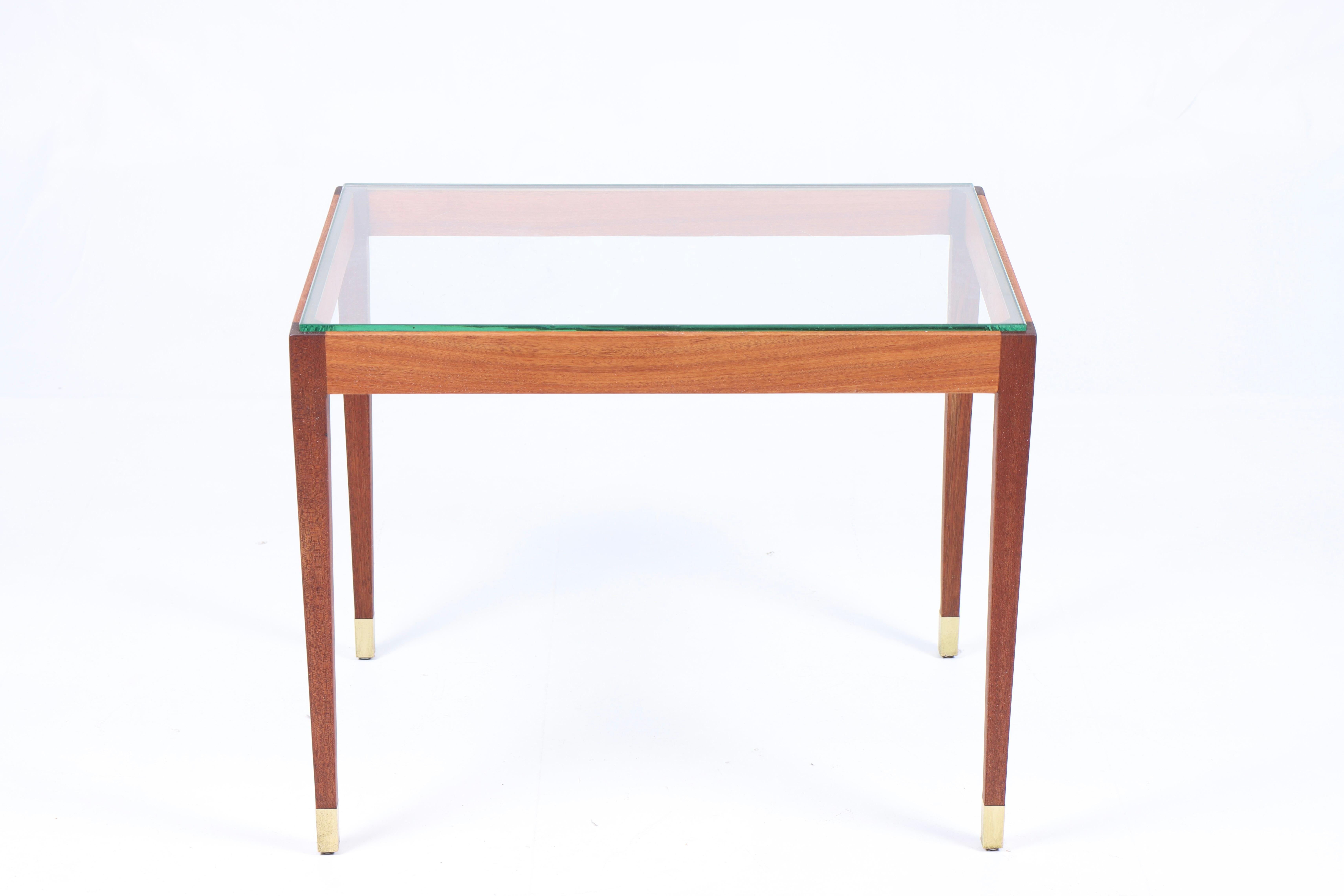 Low table in teak, brass and glass top. Designed and made in Denmark 1960s