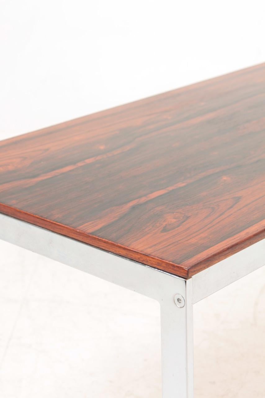 Low table in rosewood chrome frame. Designed and made in Denmark. Great original condition.