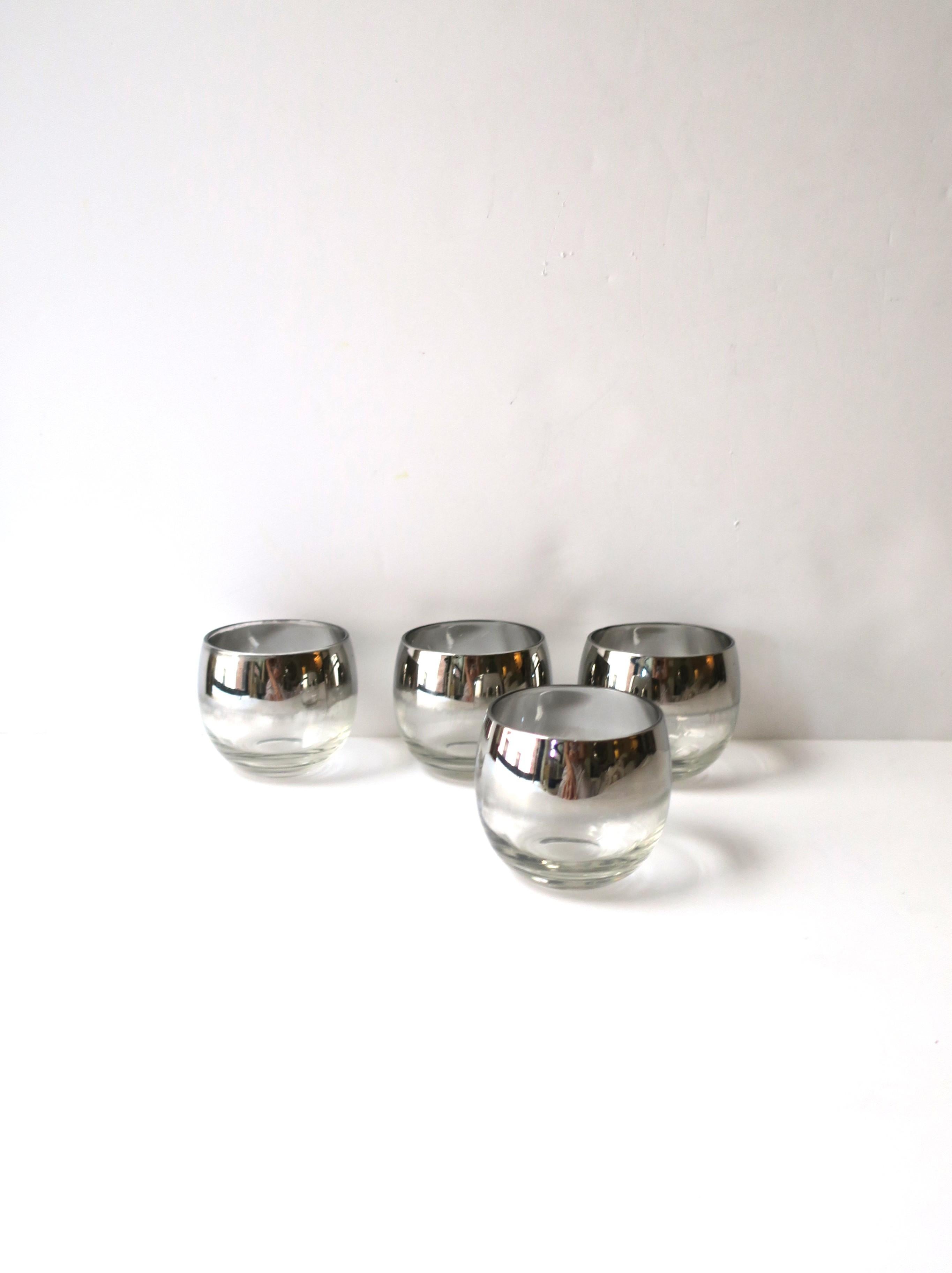 A set of four (4) silver rimmed roly-poly cocktail glasses in style of American designer Dorothy Thorpe, Mid-Century Modern period, circa mid-20th century, USA. Set has a silver/mirrored rim. A great set for cocktails, entertaining, bar, bar cart,