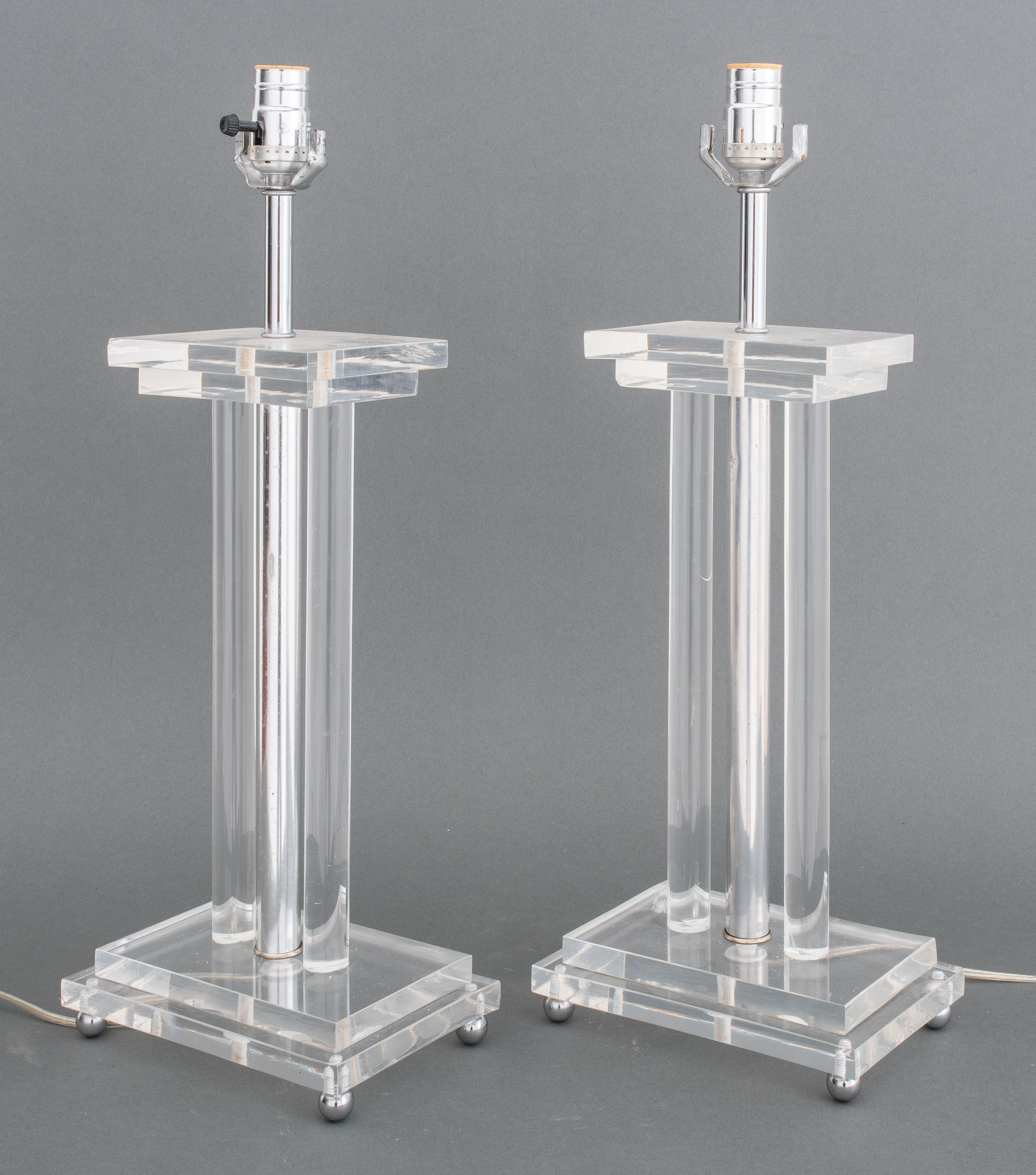 Midcentury lucite and chrome table lamps in the manner of Charles Hollis Jones, with a chrome column flanked by two lucite columns above stepped lucite base on chrome ball feet. 22
