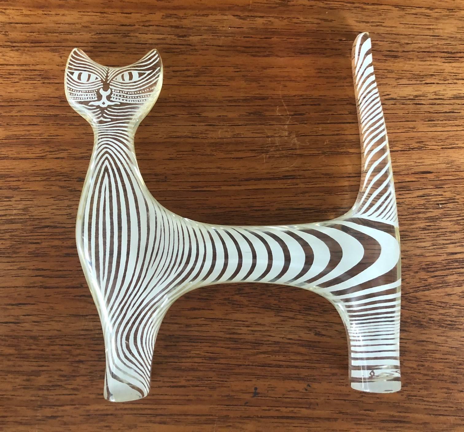 Midcentury Lucite cat sculpture by Brazilian artist Abraham Palatnik, circa 1960s. Palatnik was a Pioneer in the Kinetic and Op Art movements.
This piece of a cat with her enigmatic smile is striped in white throughout and is signed 