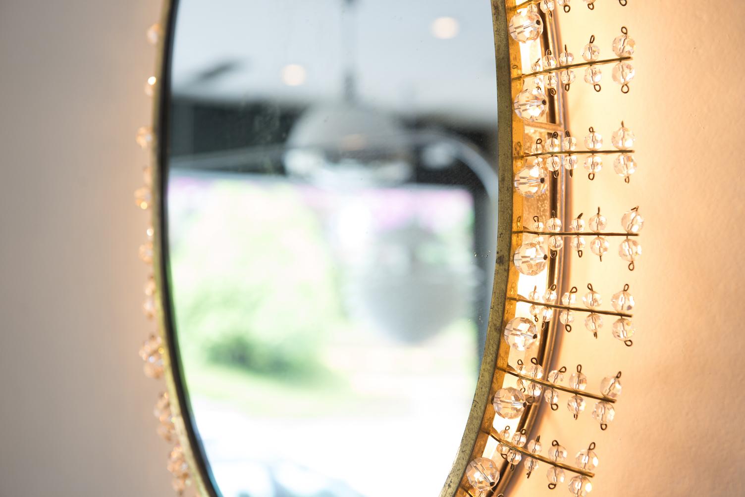 Oval midcentury brass and chrome wall luminous mirror, frame in glass faceted balls.