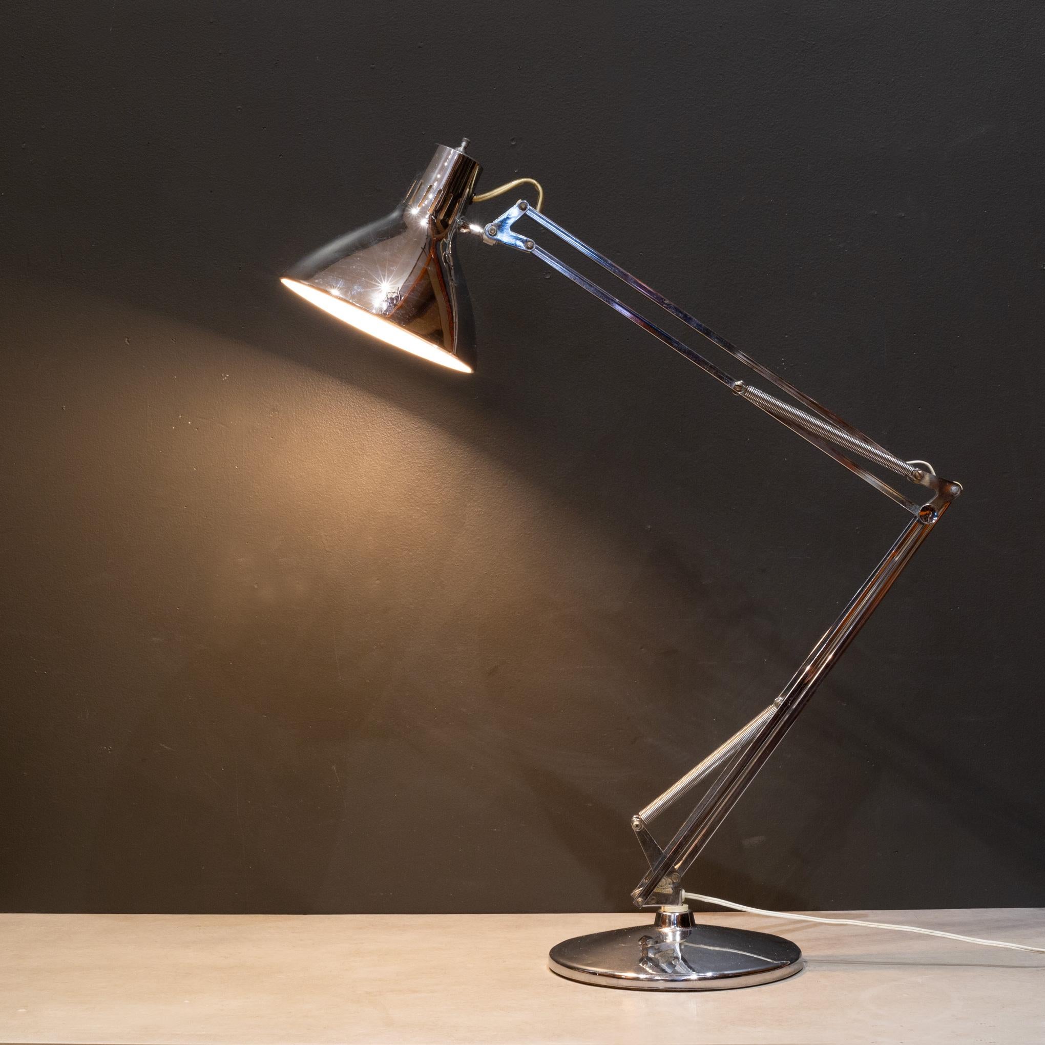 ABOUT

This is an original Luxo articulated, chrome desk lamp. A circular shade on a double-hinged spring arm on a circular foot. The shade has an inner plastic shade. 
LUXO imprint stamp on the base and original lable. This piece has retained its