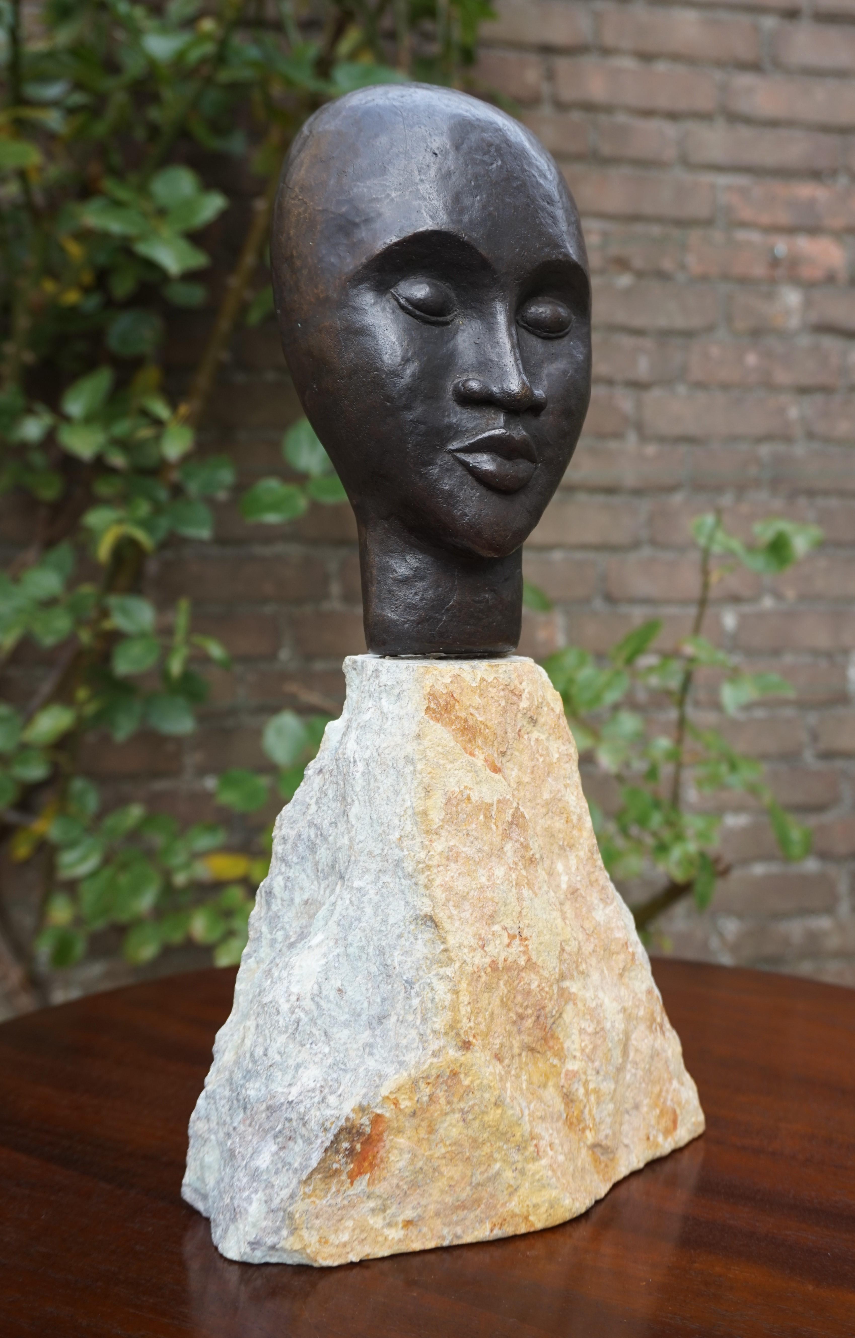 Wonderful sculpture and a beautiful, mixed materials work of art.

This serene yet strong face on a beautiful mineral stone base 'spoke to me'. For me that has always been the best reason for purchasing an antique or a modern work of art. The