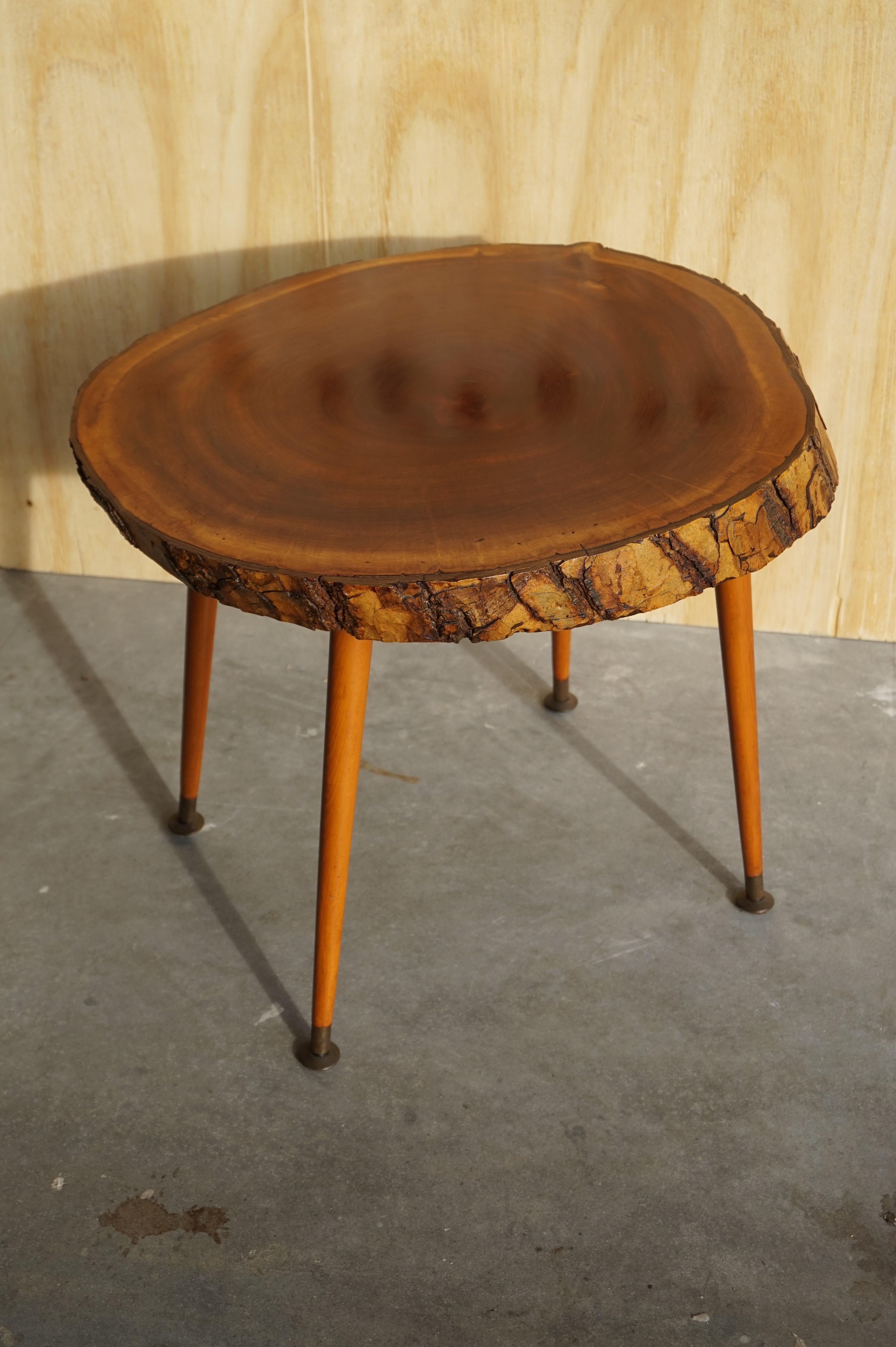 Handcrafted and organically beautiful 1950s table.

This handcrafted table from the midcentury era is both beautiful and functional. The natural material tabletop is made of a stunning slice of timber and it even comes with the original bark. The