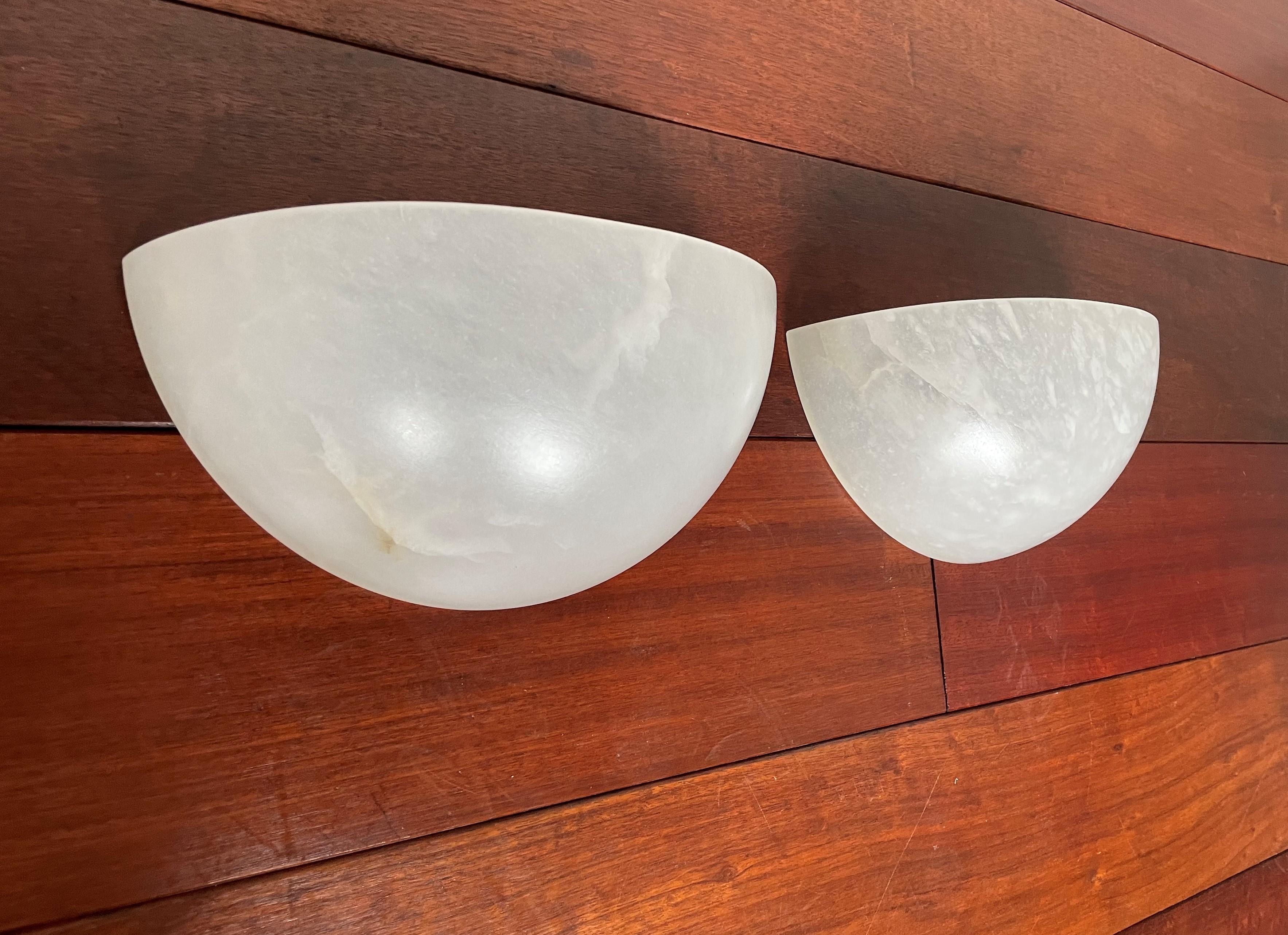 Great looking and easy to mount pair of pure white alabaster wall sconces.

If you are looking for a stylish way to bring light into your entry hall, stairwell, kitchen or bedroom or if you are looking for the perfect wall lights over your side