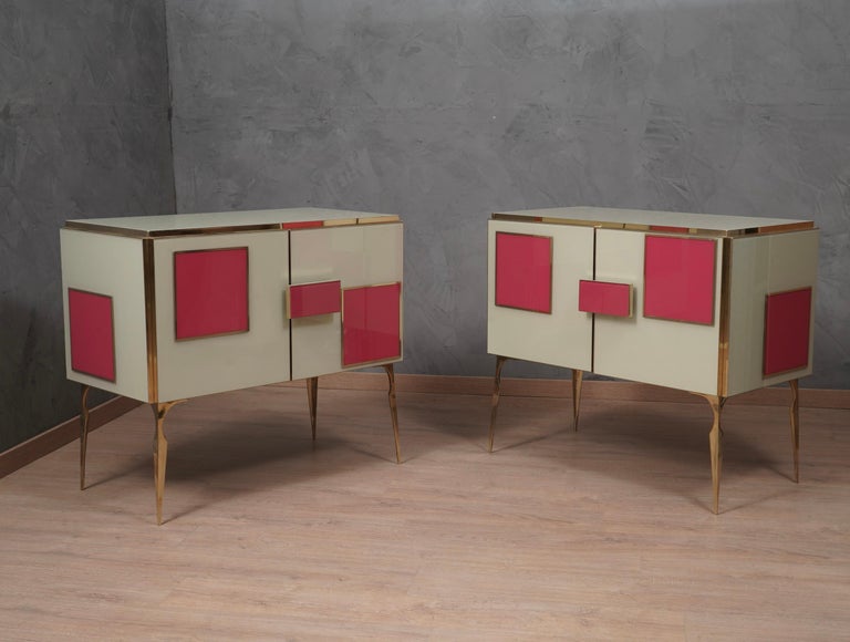 A unique sideboard of its kind for its originality and for the choice of materials. Simple but refined design, note the veneer and polished very well in the internal part. Note the rich design of the doors, with smooth colored glass interspaced with