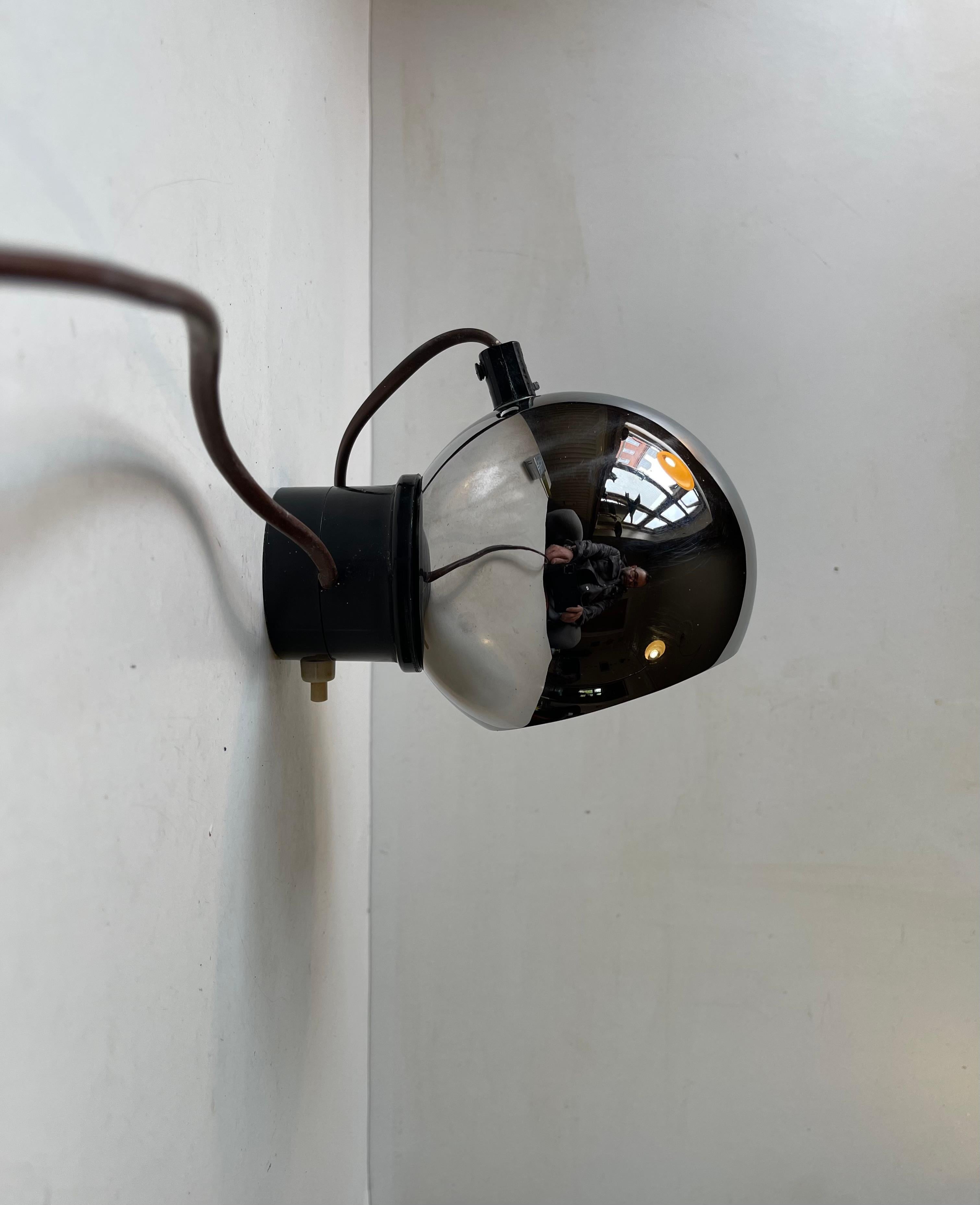A very versatile wall light that can be adjusted in every direction due to its magnetic wall mount. It is commonly referred to as an eye-ball sconce for obvious reasons. Inspired by Verner Panton's Topan from 1962 this particular example was