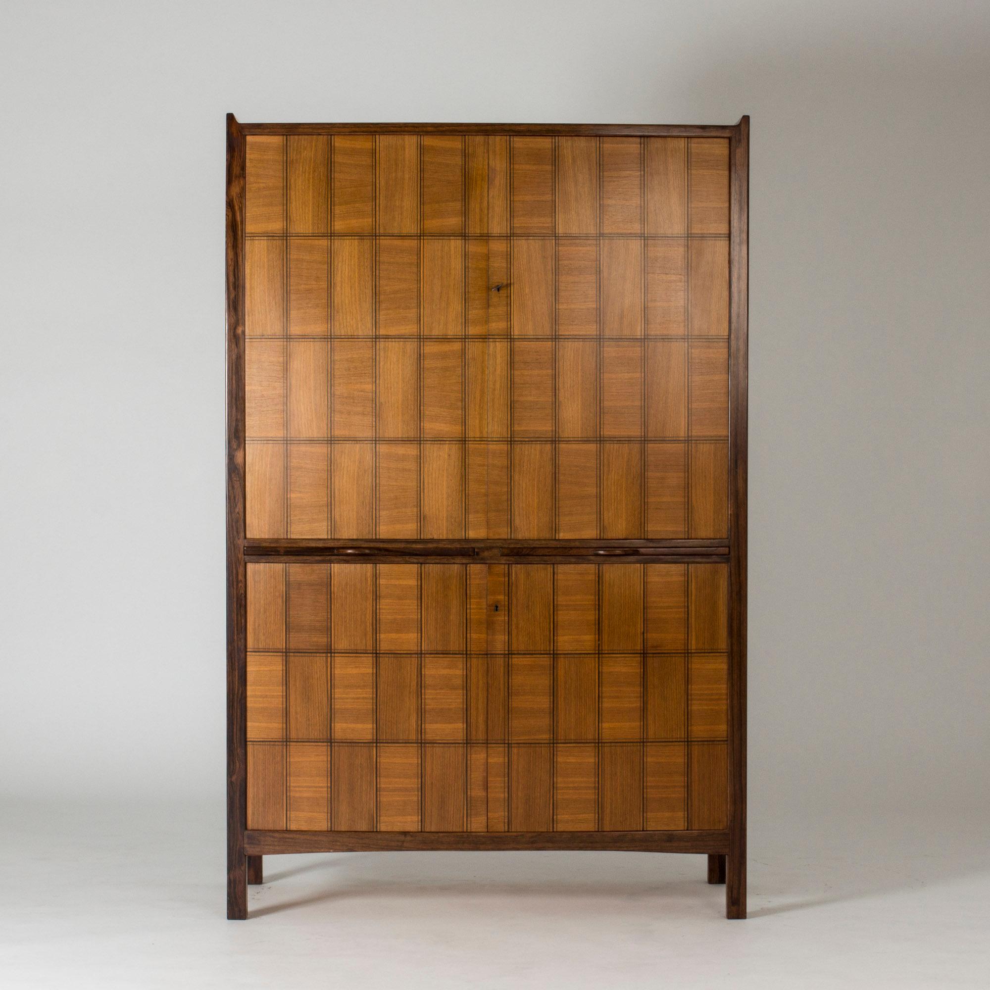 Stunning mahogany and rosewood cabinet designed by David Rosén and made by master carpenter Thomas Lindell as his apprentice’s examination work. The cabinet took a year to finish, with its elaborate checkered inlays and sculpted details the top and