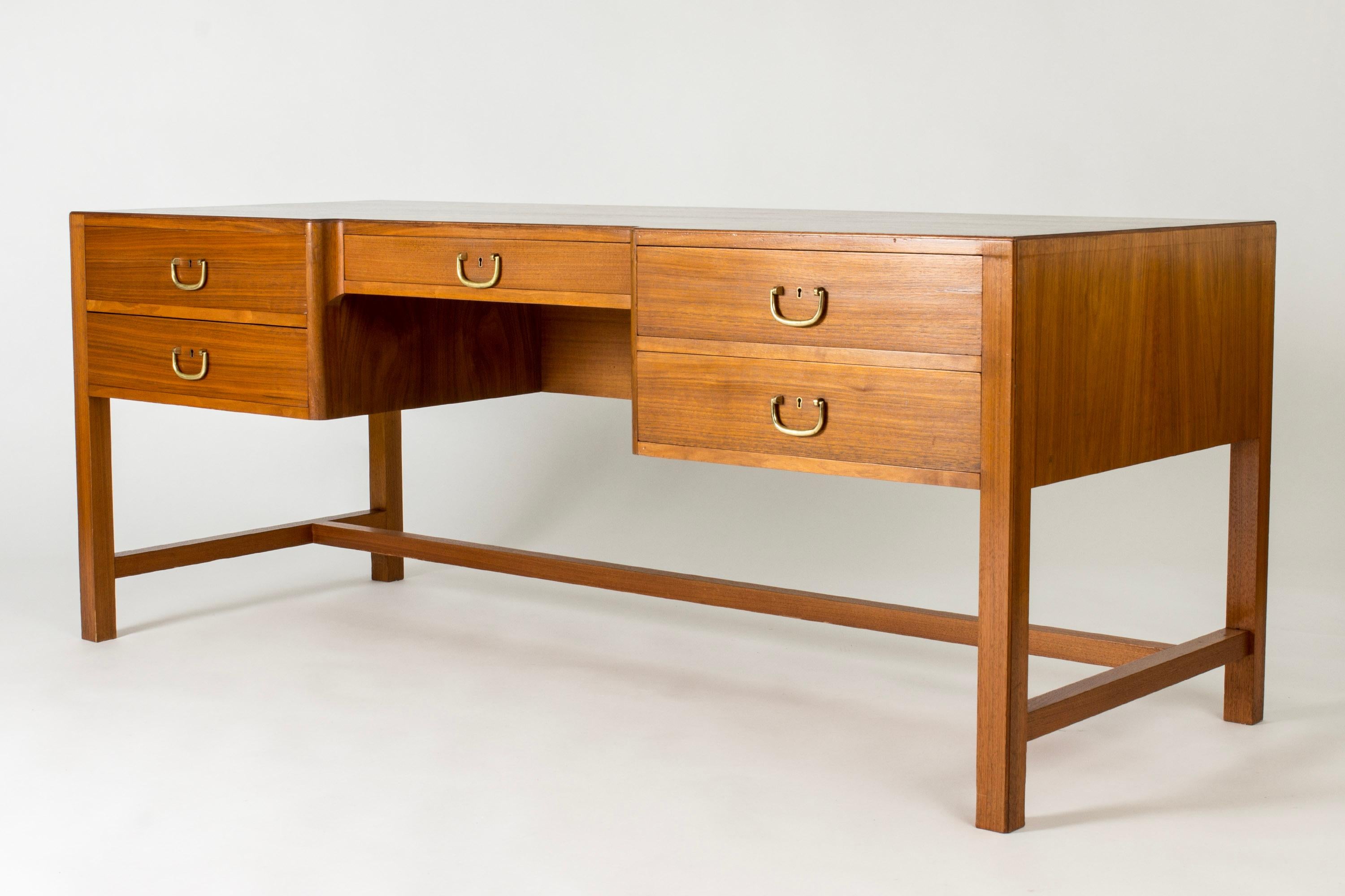 Large, elegant mahogany desk by Josef Frank. Beautiful veneer, warm in color. Brass handles.