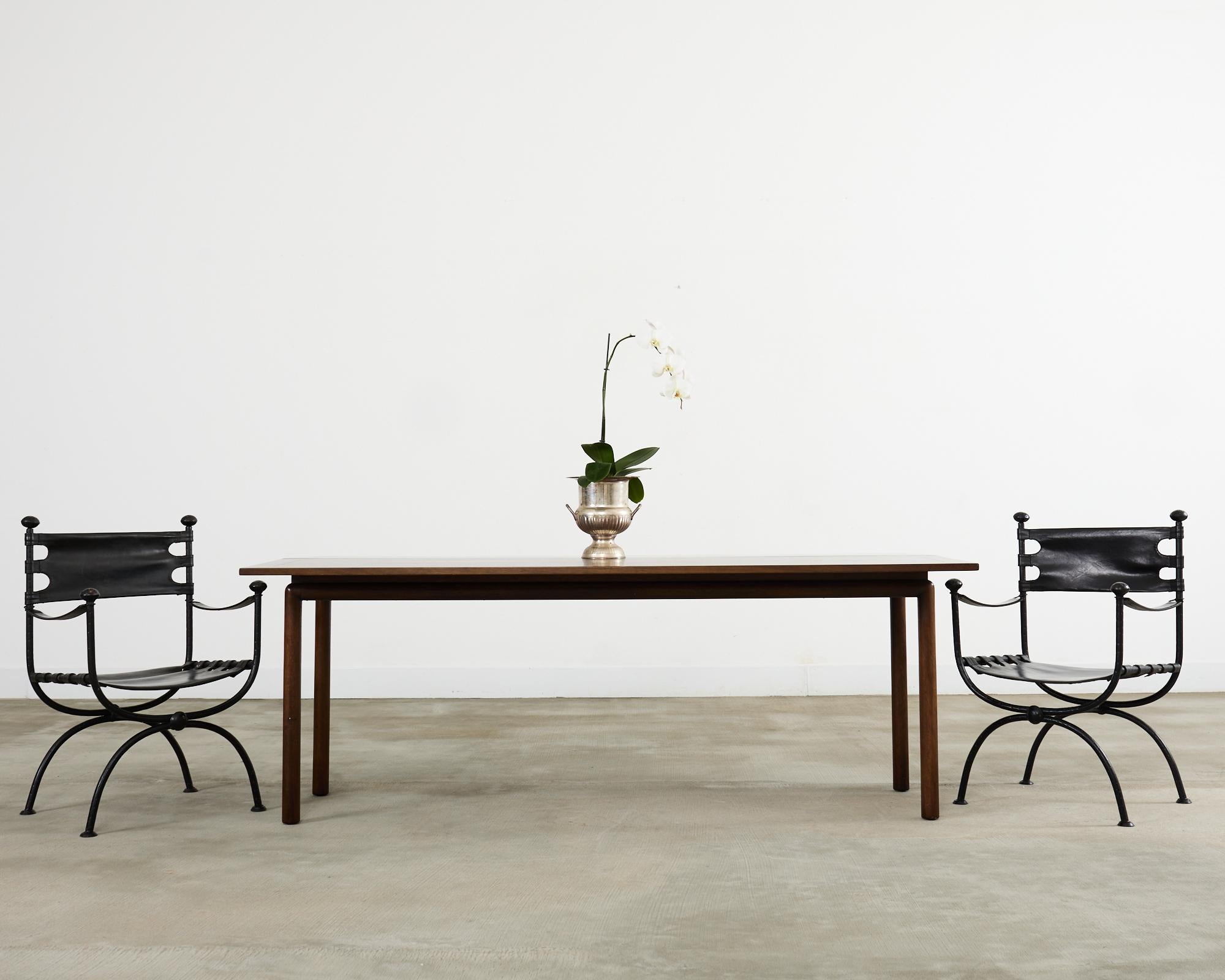 Elegant mid-century modern console table, dining table, or games table by Kittinger. The Japanese inspired table features a flip-top that expands the top from 20 inches to over 40 inches deep. The top is supported by a base with round legs and