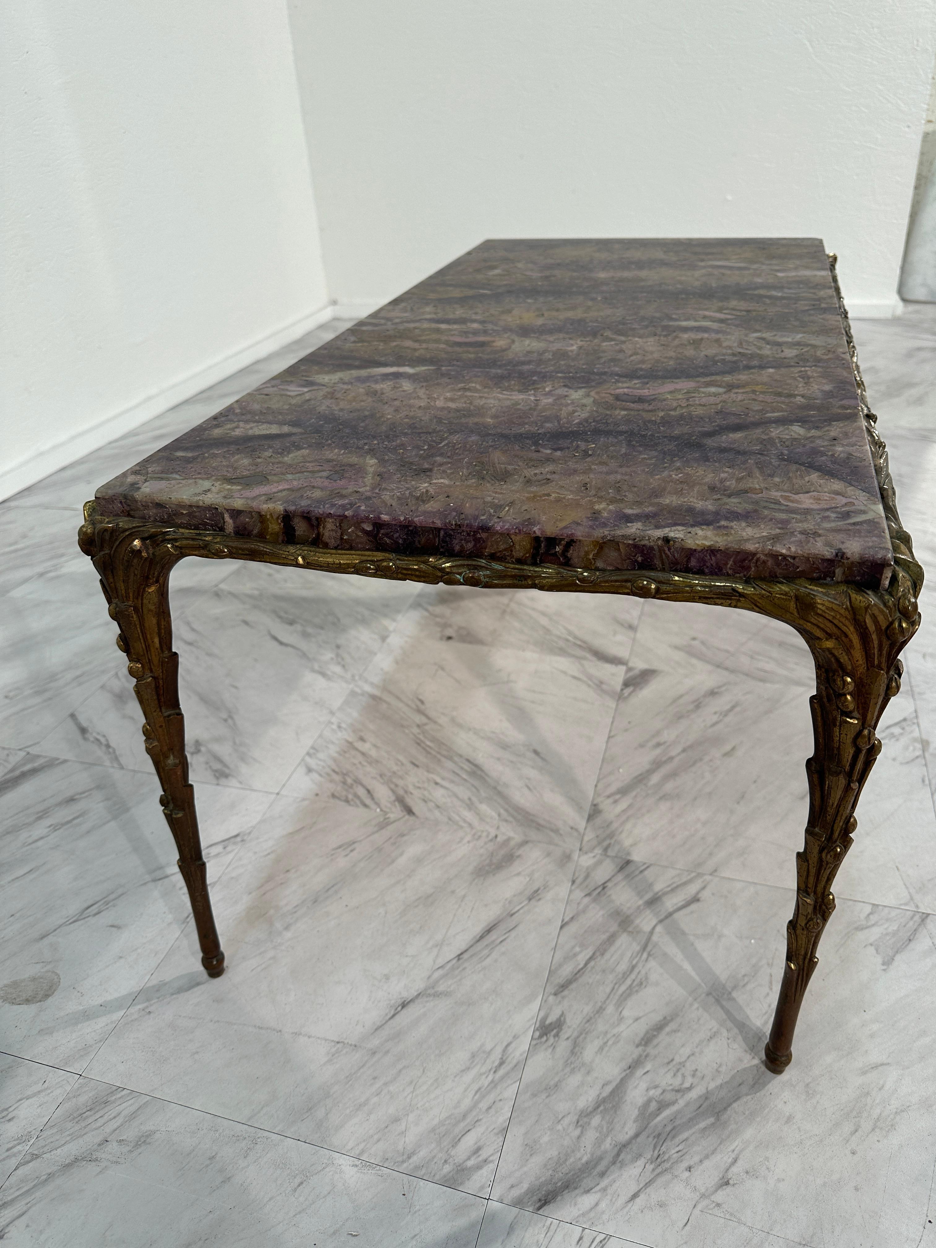 The Midcentury Maison Bagues French Bronze Coffee Table from the 1970s is a captivating blend of elegance and avant-garde design. Its base, resembling melted bronze, exudes a mesmerizing allure, showcasing innovative craftsmanship. Paired with a