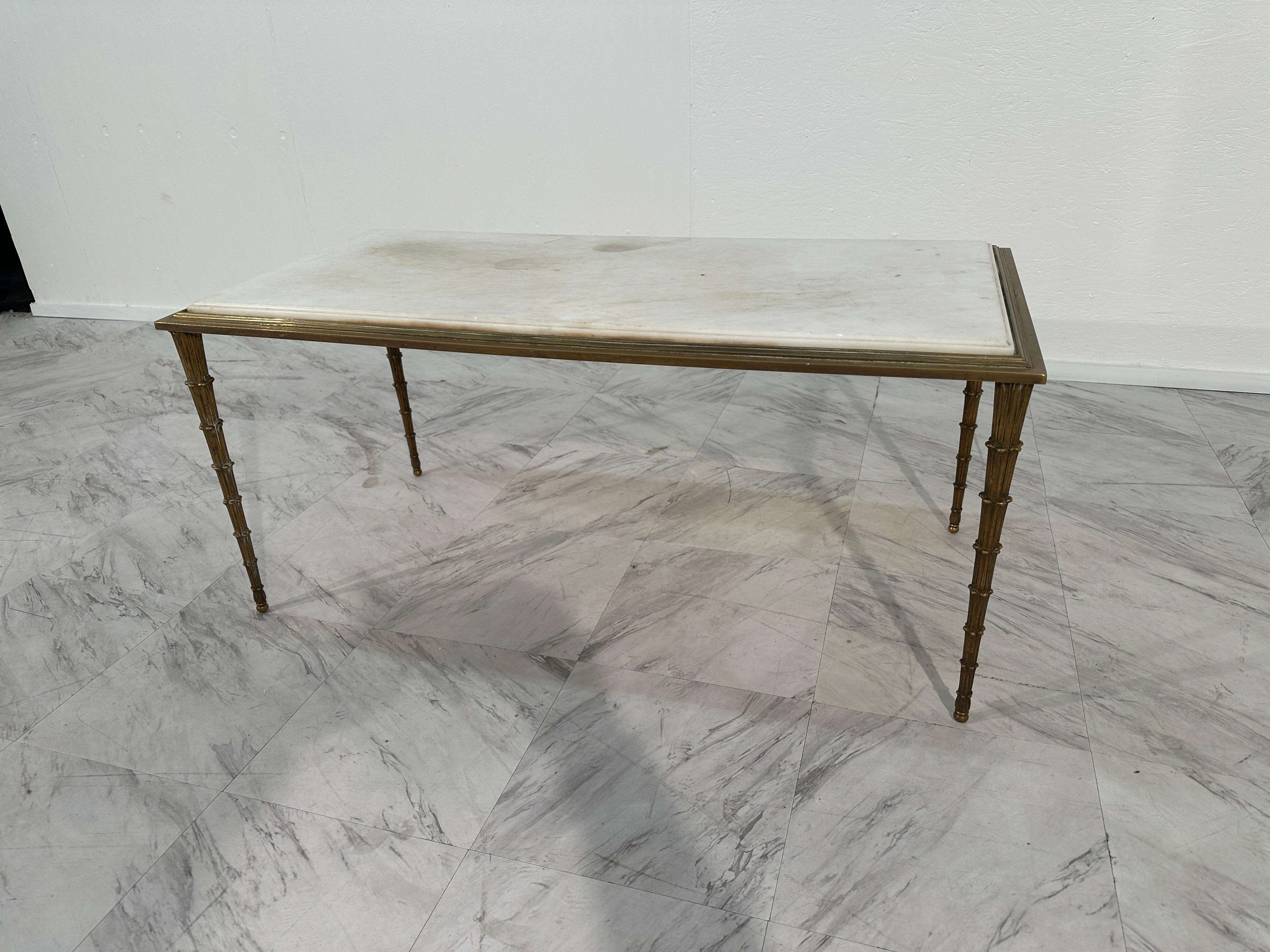 The Midcentury Maison Bagues French Bronze Coffee Table from the 1970s is a captivating blend of elegance and avant-garde design. Its base, resembling melted bronze, exudes a mesmerizing allure, showcasing innovative craftsmanship. Paired with a