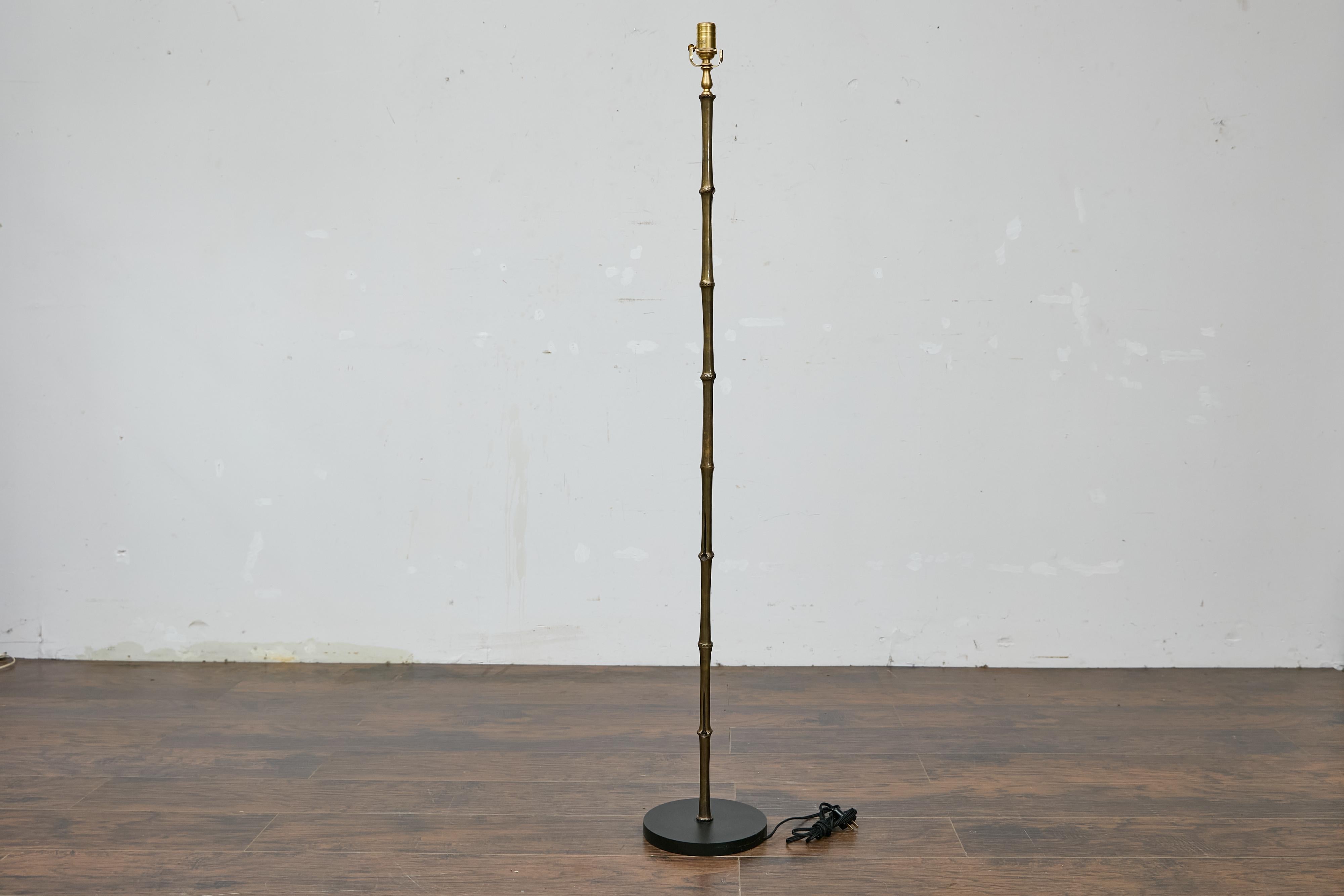 A Maison Baguès inspired faux bamboo steel floor lamp from the Midcentury period, on circular base. This Maison Baguès inspired faux bamboo steel floor lamp from the Midcentury period exudes a refined and subtle elegance, perfectly capturing the