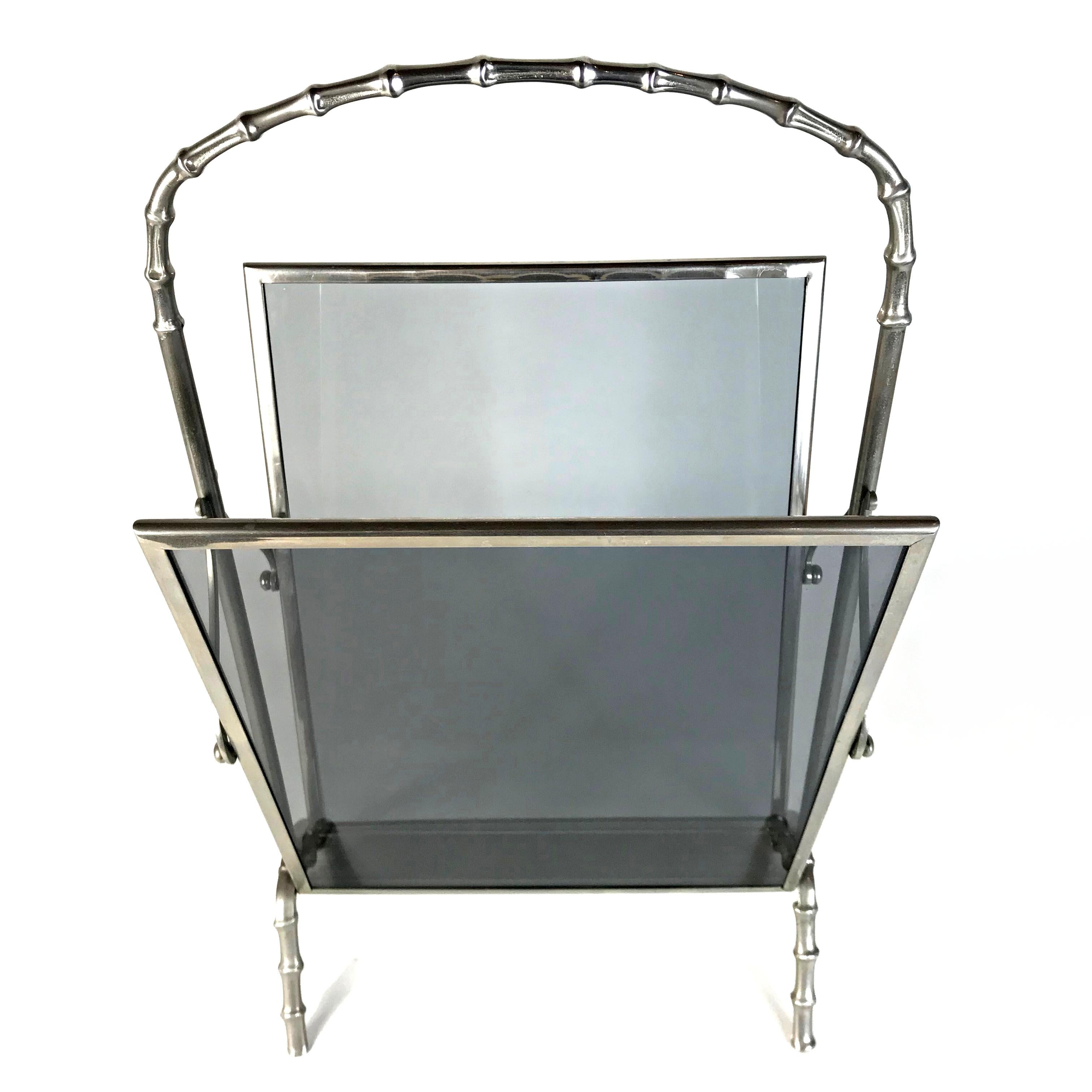 Beautiful faux bamboo magazine rack in heavy silvered brass with smoked grey glass plates by Maison Baguès Paris. Very good condition. We also have the matching serving cart in stock.
Maison Baguès is renowned for Fine brass objects and lights