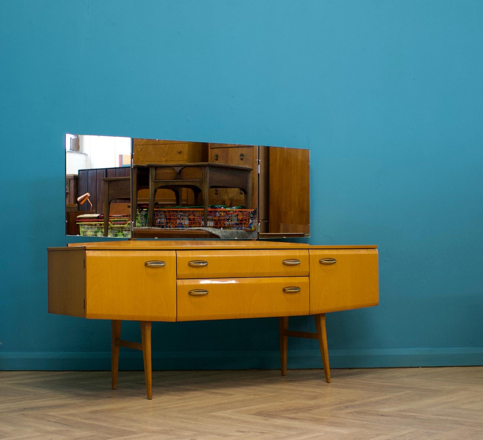 A mid century Italian style maple dressing table  - from the quality furniture makers, Meredew, circa 1960s
There are two drawers and two cupboards
Finished in high gloss


The matching chest of drawers are listed for sale separately


Height to the