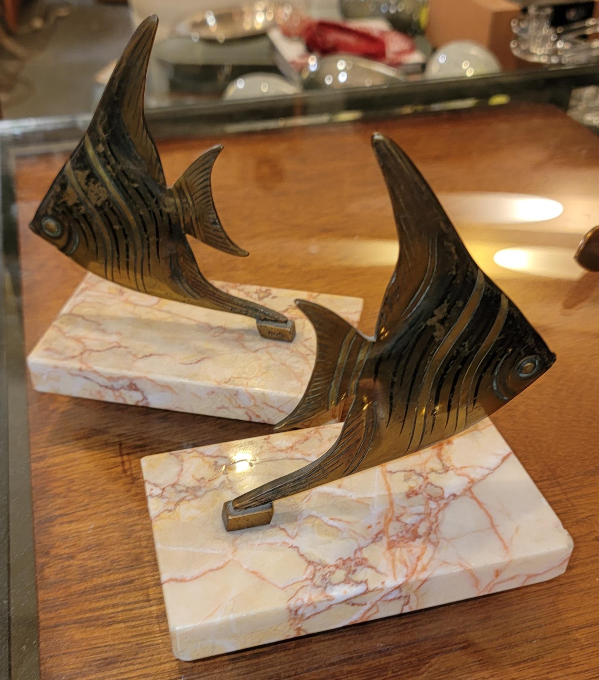 Pair of fish bookends with marble pinkish base and brass angel fish. Measures approx - 3.25deep x 5 wide x 6.25 high.