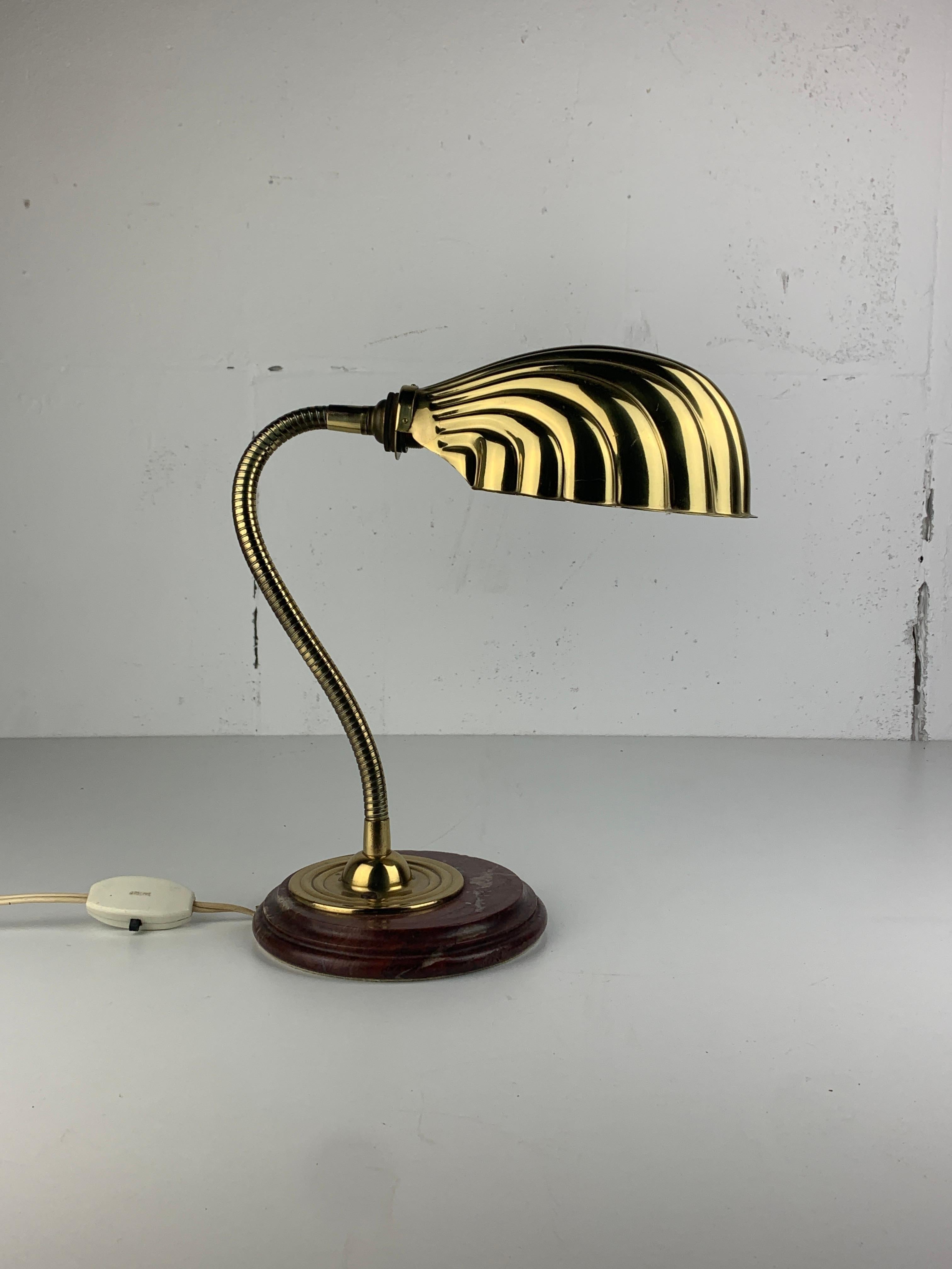 Gorgeous adjustable clam shell and sometimes referred to as scallop lamp which originally was attributed to Tommaso Barbi but as the lamp is not marked we've changed that to in the style of. This lamp is in great vintage condition. The brass is in a