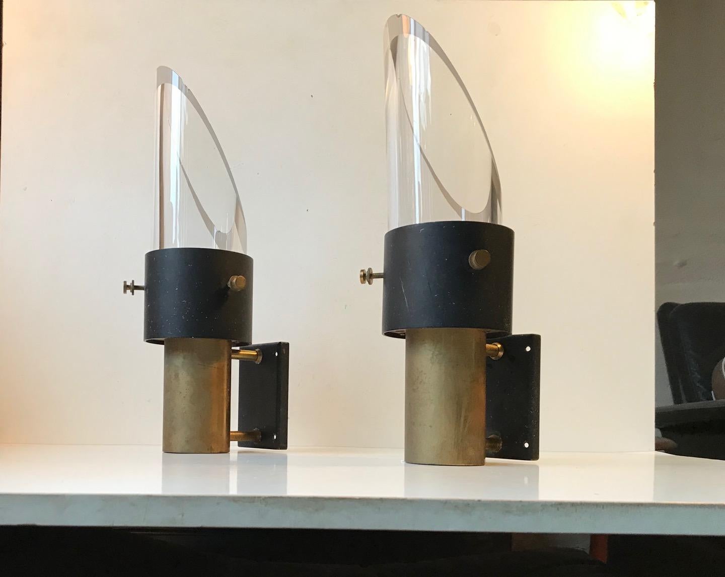 A pair of midcentury wall lamps made by Lyfa in Denmark in collaboration with the Swedish company Orrefors. The design is attributed to Kay Kørbing who designed these for two school ships: M/S Princesse Margrethe and M/S Winston Churchill. The body