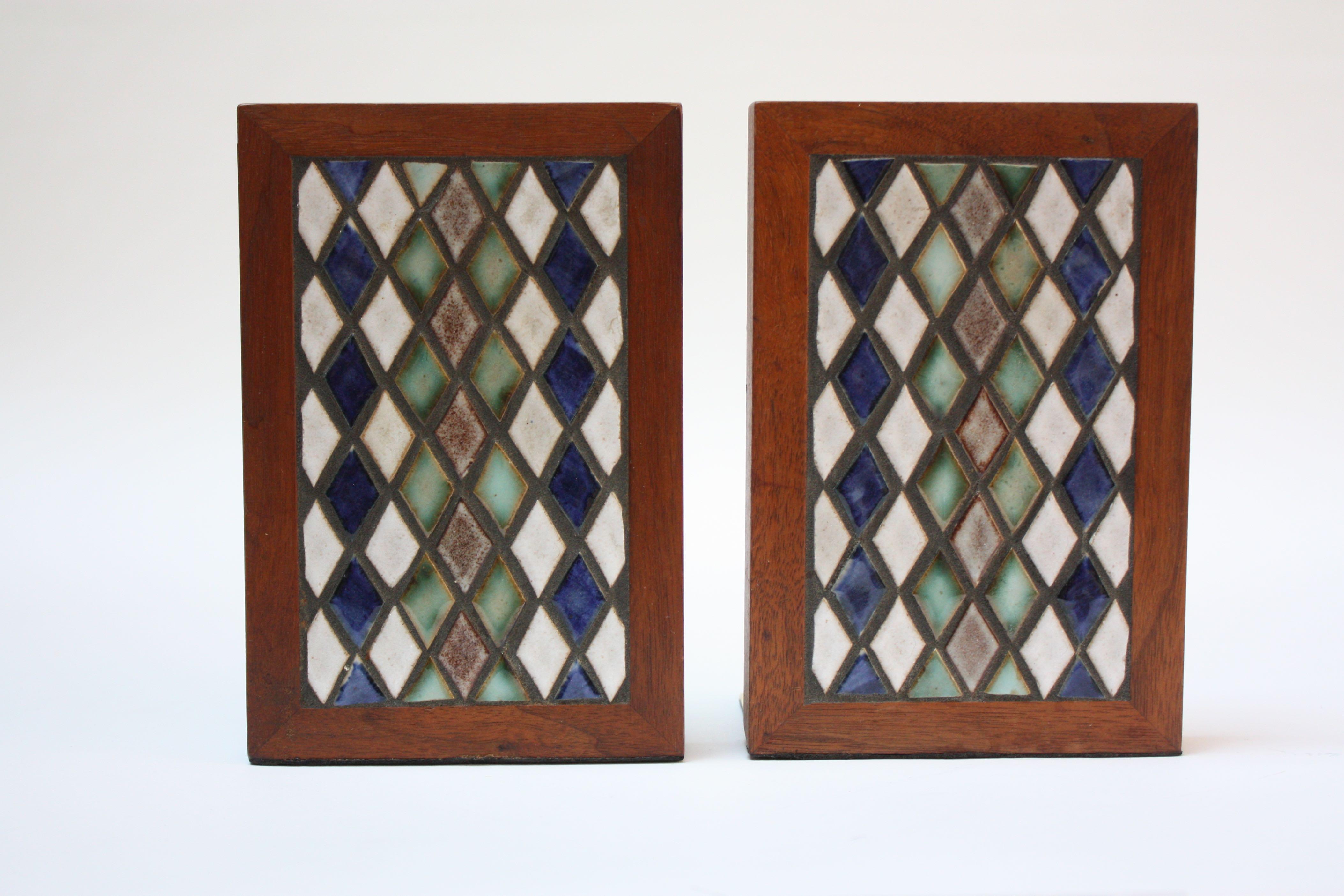 Pair of Gordon and Jane Martz for Marshall Studios walnut and brass bookends with ceramic diamond tile inlay (model #TBE1-21, circa 1957). Boasts vibrant colors of taupe, green, blue and white. Ceramic and walnut are pristine; brass to one of the